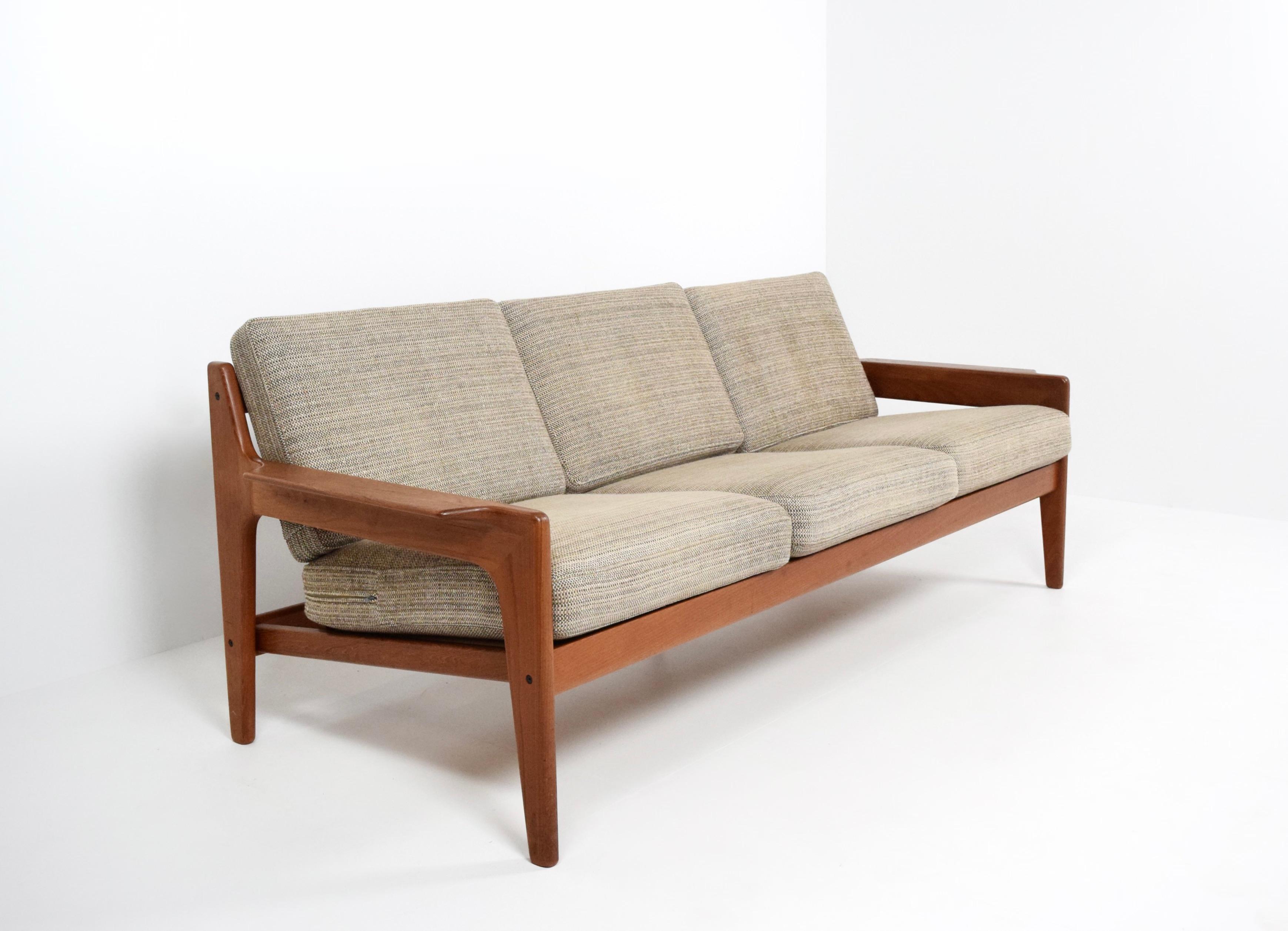 Stylish Arne Wahl Iversen three-seat sofa for Komfort from Denmark. This solid teak sofa has a very clean design with the characteristic elements for midcentury Danish design. The armrests and back of the sofa particularly stand out, having an