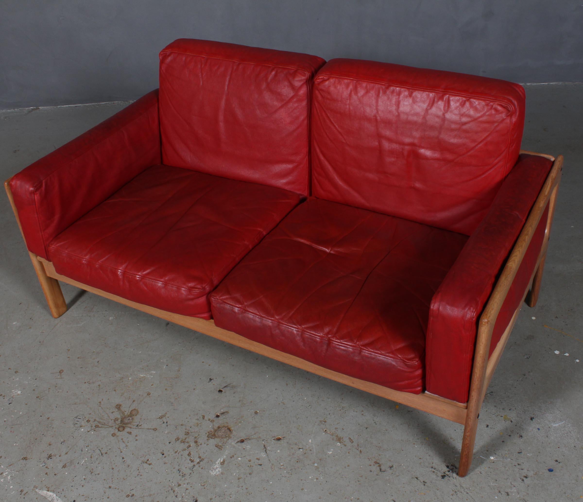 Arne Wahl Iversen. Two seat sofa, with frame of oak. Original cushions with red leather.
Manufactured by Komfort.

 