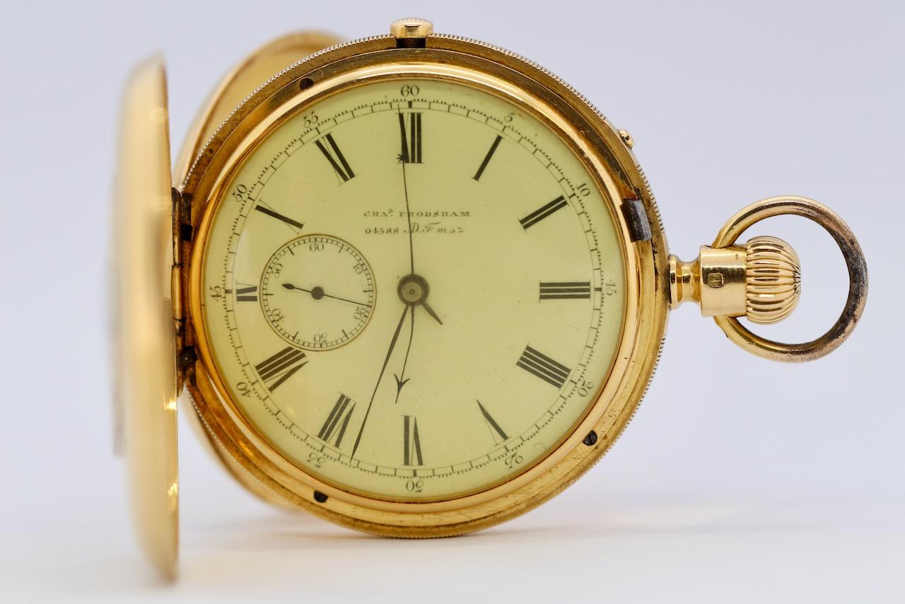 This rare and elegant half-hunter pocket watch by Arnold & Chas. Frodsham is a true collector’s piece, crafted from solid 18K gold with a triple-hinged case. Weighing an impressive 126 grams, this distinguished timepiece exudes 19th-century British