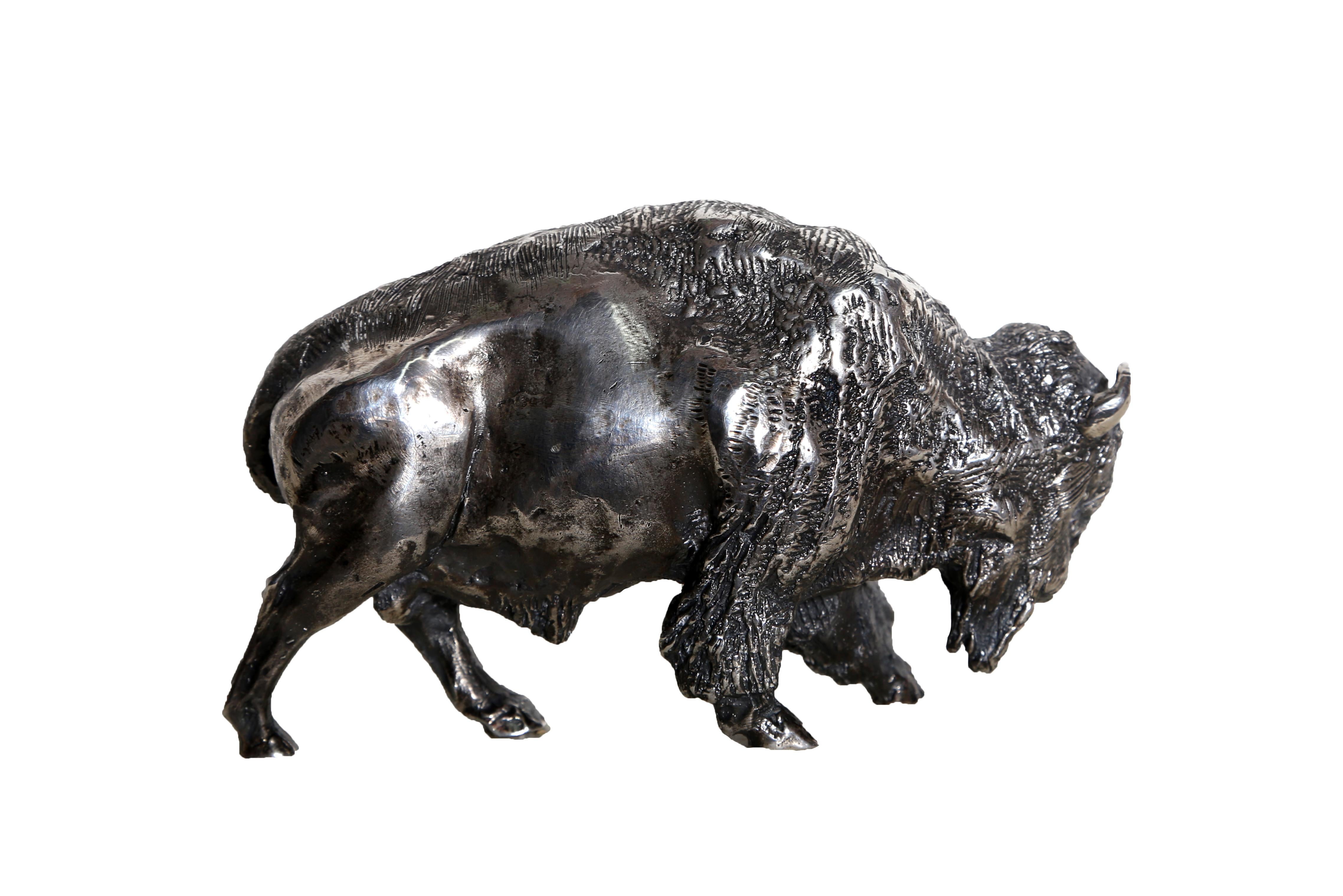 Silver cast metal sculpture of an American buffalo created by American artist Arnold Goldstein. This artwork has the signature inscribed on the belly.