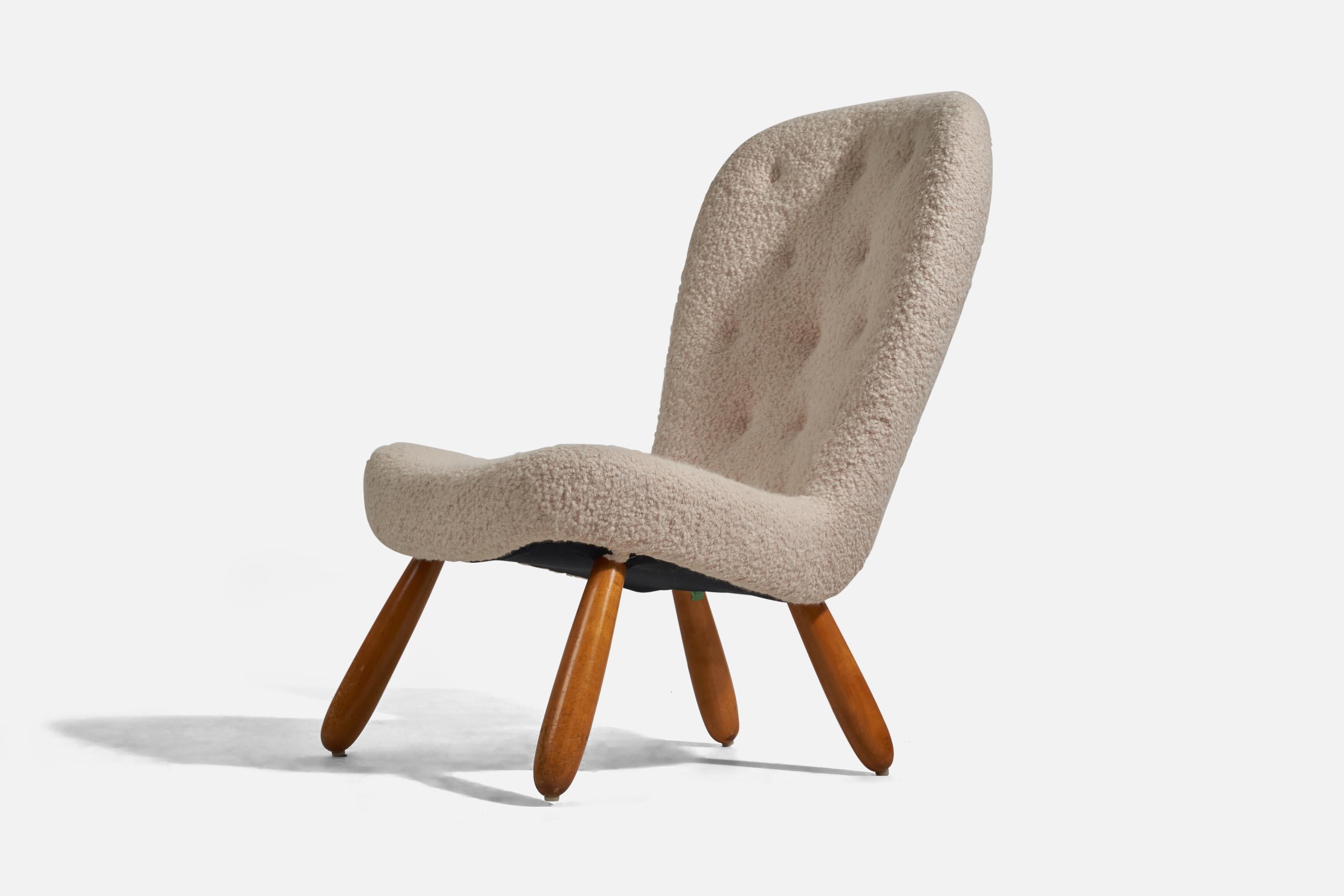 A sheepskin and beech lounge chair; design and production attributed to Arnold Madsen, Denmark, 1950s. 