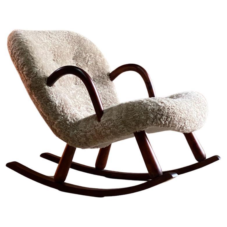 Arnold Madsen clam rocking chair Norway circa 1950s

Sublime mid twentieth century Arnold Madsen clam rocking chair Norway circa 1950s, this rare and stunning rocking chair has been fully restored and recovered in the finest Mohawi sheepskin, the