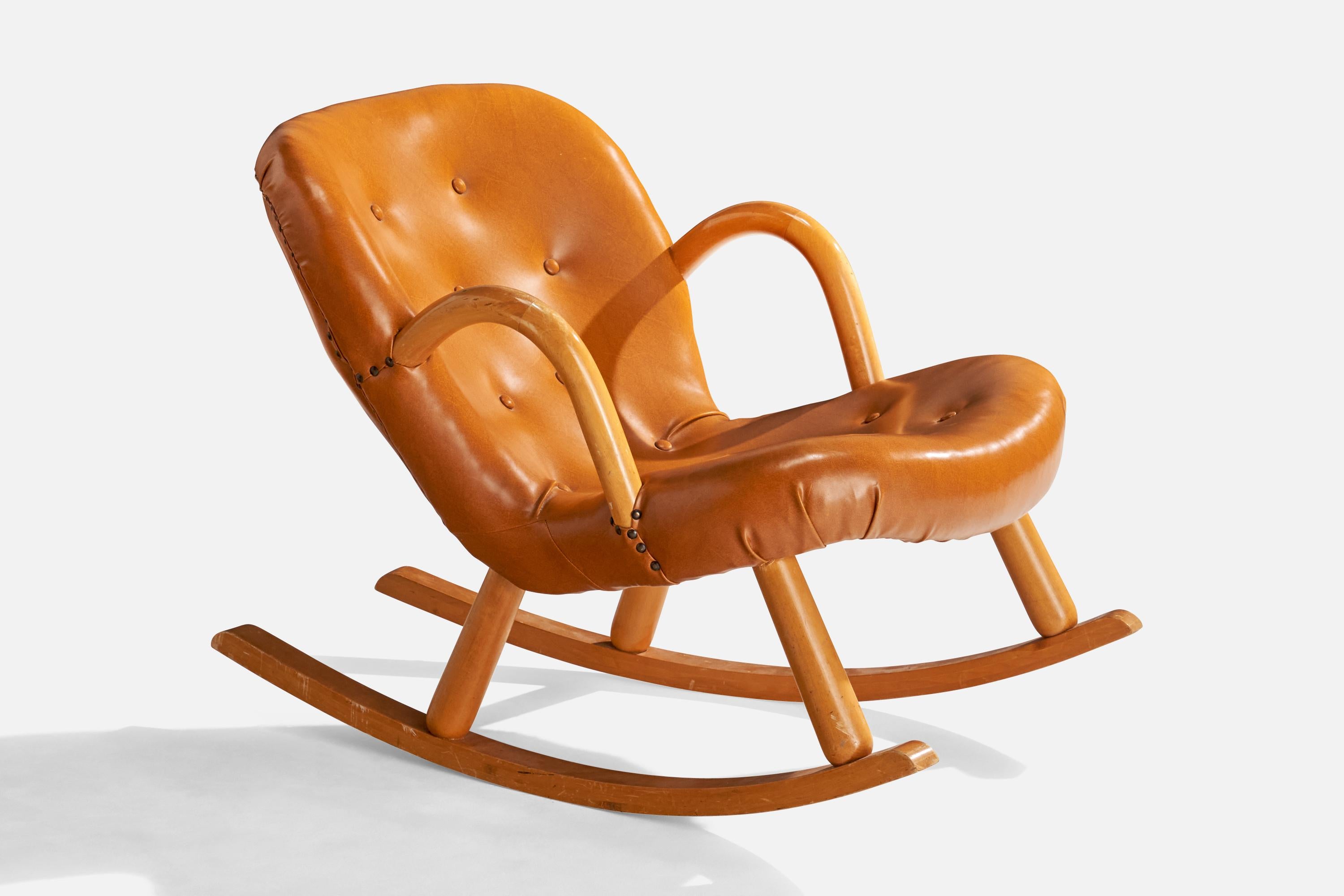 A beech and brown leatherette rocking lounge chair designed by Arnold Madsen and likely license-produced in Sweden, c. 1950s.

Seat height: 12.75