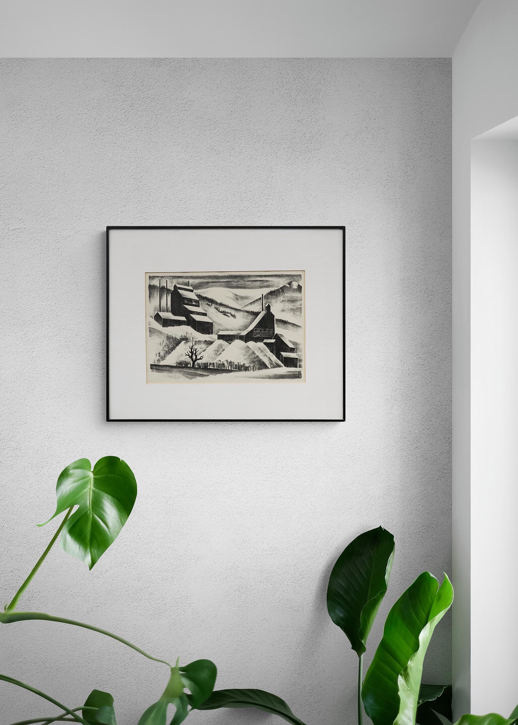 Lithograph on paper titled 'Mine Near Continental Divide' by Arnold Ronnebeck (1885-1947) from 1933. Depicts a black and white winter scene of a mine in the mountains with snow on the rooftops and hillsides. Presented in a custom frame measuring 18