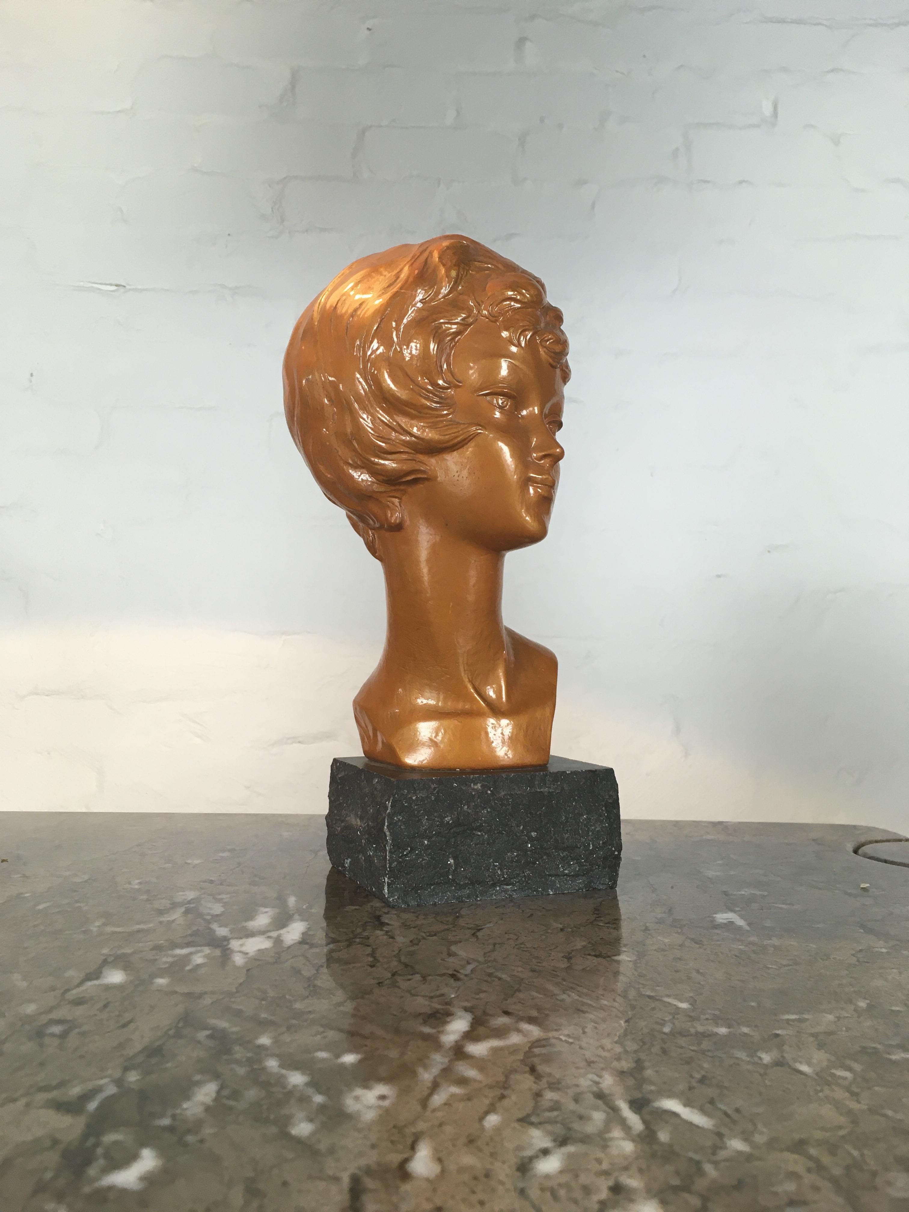 An elegant bust of a young lady, clearly based on Brigitte Bardot, by the Arnova company. The bust is attached to a very nicely made granite base, and signed to the back R.I. 369 B.B.

Probably the artist initials, the model number and B.B., a