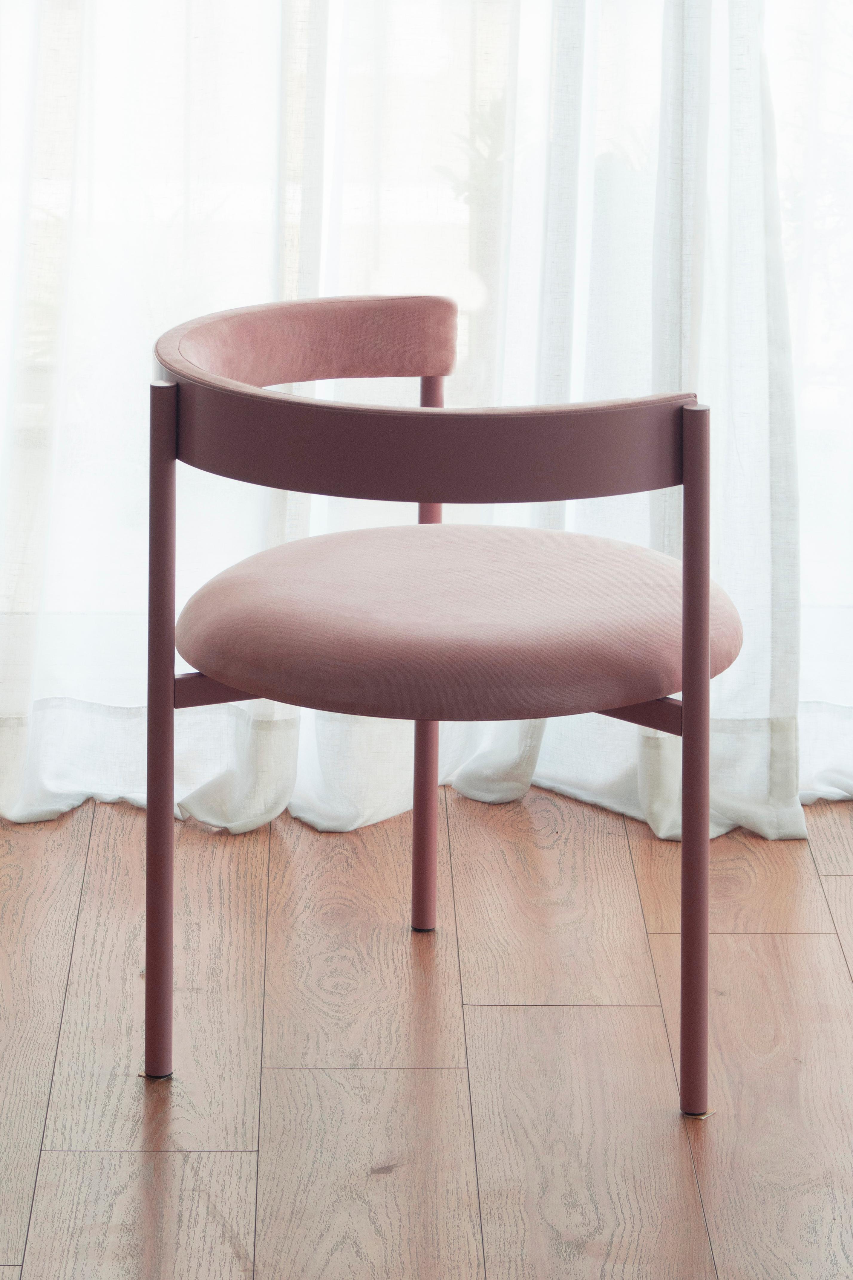 Aro chair, Pink by Ries
Dimensions: W60 x D60 x H67,5 cm 
Materials: Round steel tube, high-density foam, and velvet upholstery.

Also available: Merlot,black, yellow, mika, oceano, and dark blue.

Ries is a design studio based in Buenos