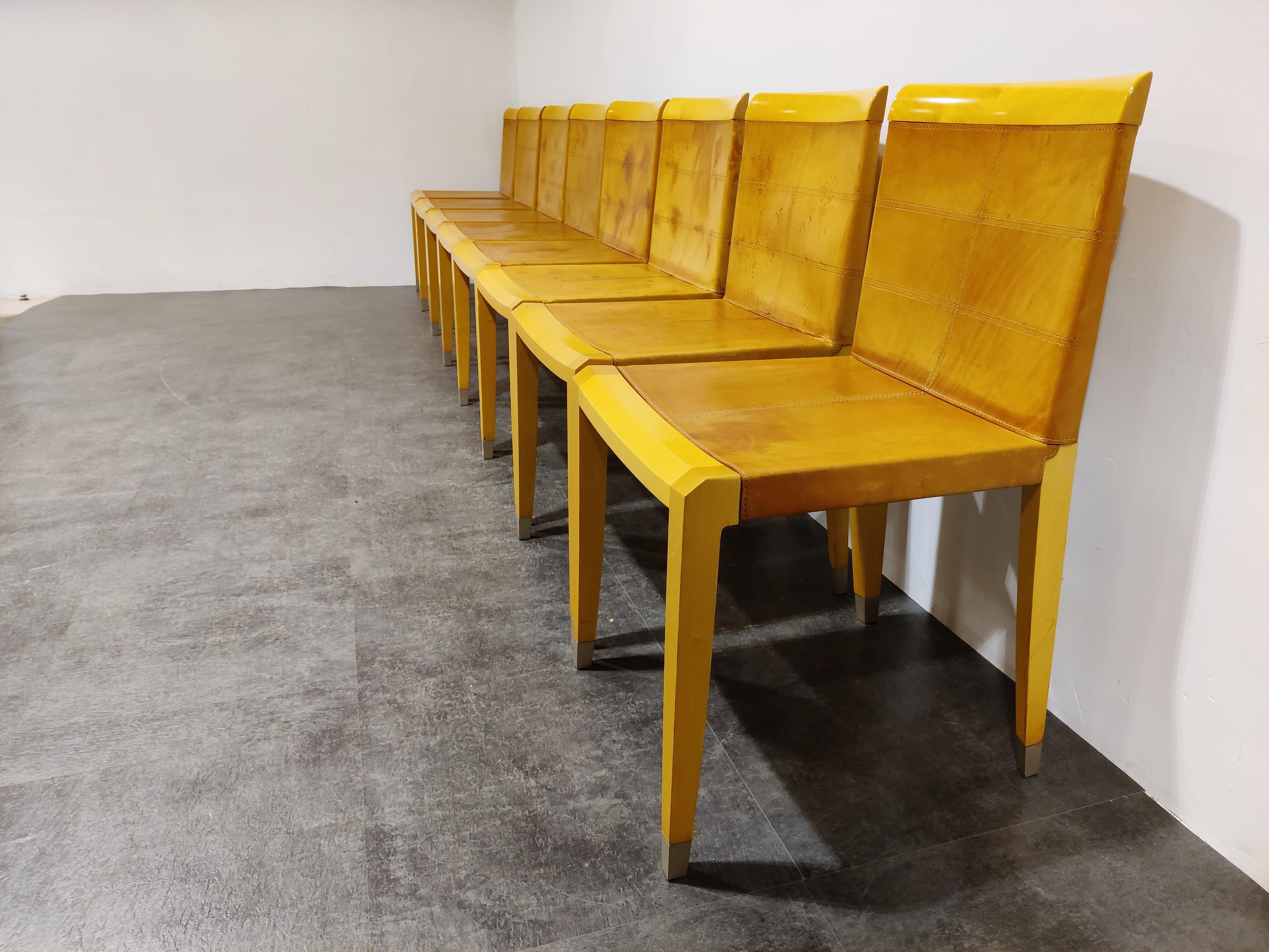 1990s dining chairs with cherry wooden frames, metal foot caps and brown patinated saddel leather upholstery.

The chairs have abeaiutiful, sleek and elegant design and live up to the high quality Giorgetti standards.

These chairs date from the