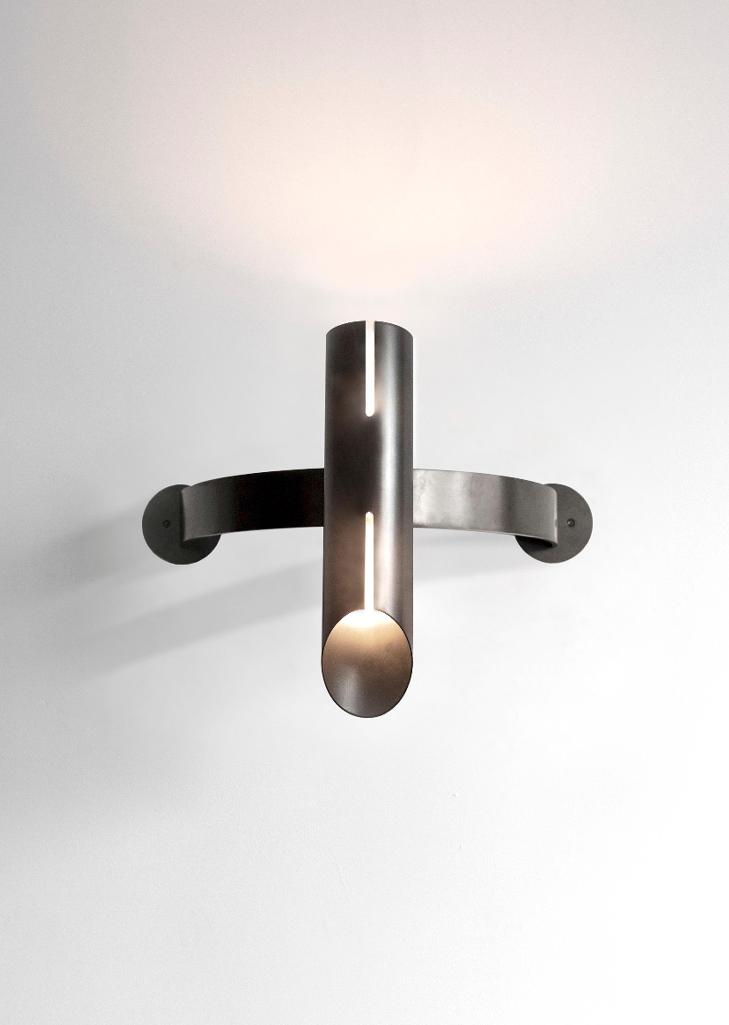 The Aro collection further explores the industrial design inspiration of the Switch and Navis collections with a more robust profile.

The Aro Half-Moon sconce extends the fixture’s projection by pairing the curvilinear extension with the strong