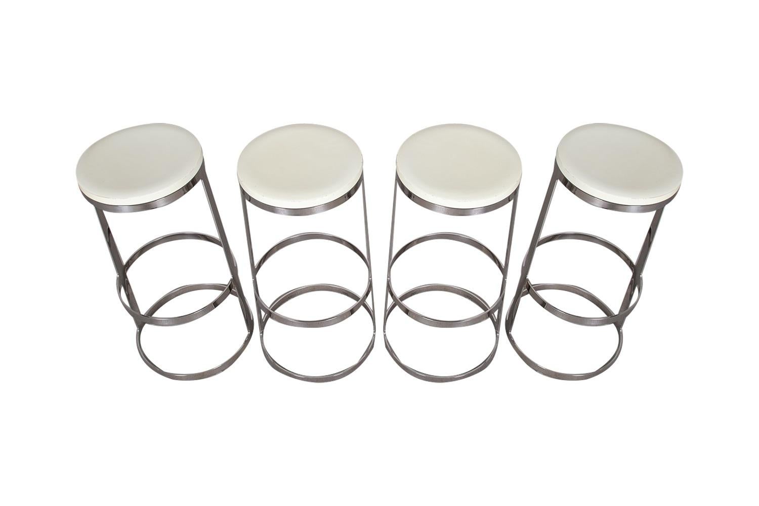 A beautiful set of four mid-century modern Aro swivel bar stools by Lievore Altherr Molina for Bernhardt Design. Offers the perfect blend of simplicity, balance and function to create a modern elegance that can work with any decorating style.