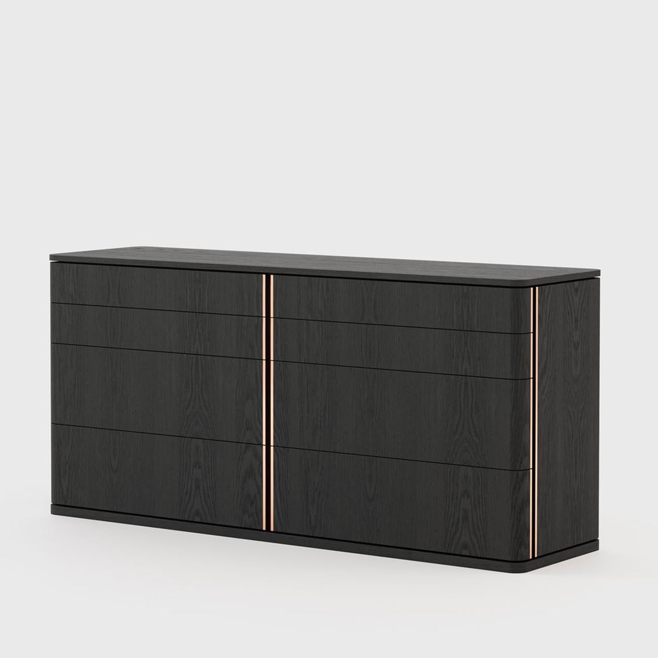 Chest of drawer Aroa large with solid wood structure, in black
ash finish. With 8 drawers on easy glide metal runners with
polished stainless steel edging trim in copper finish or in brass
finish or in chrome finish with an edging trim reminder the