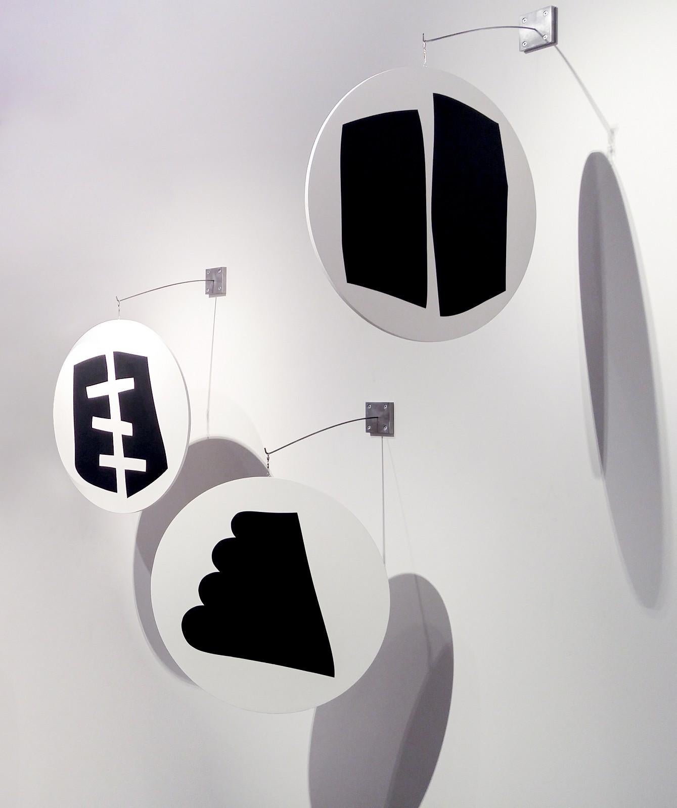 A Group of 3 Rounds containing various Black Shapes - hanging wall sculpture - Sculpture by Aron Hill