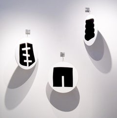 A Group of 3 Rounds containing various Black Shapes - hanging wall sculpture