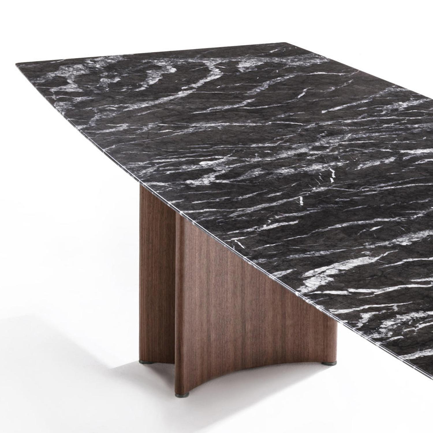 Dining table around marble with 2 curved solid 
walnut bases each sides with metal end-feet. With 
curved shaped polished dark grey marble top (20mm thickness).
Marble top with bevelled outline edge.
Also available on request with calacatta
