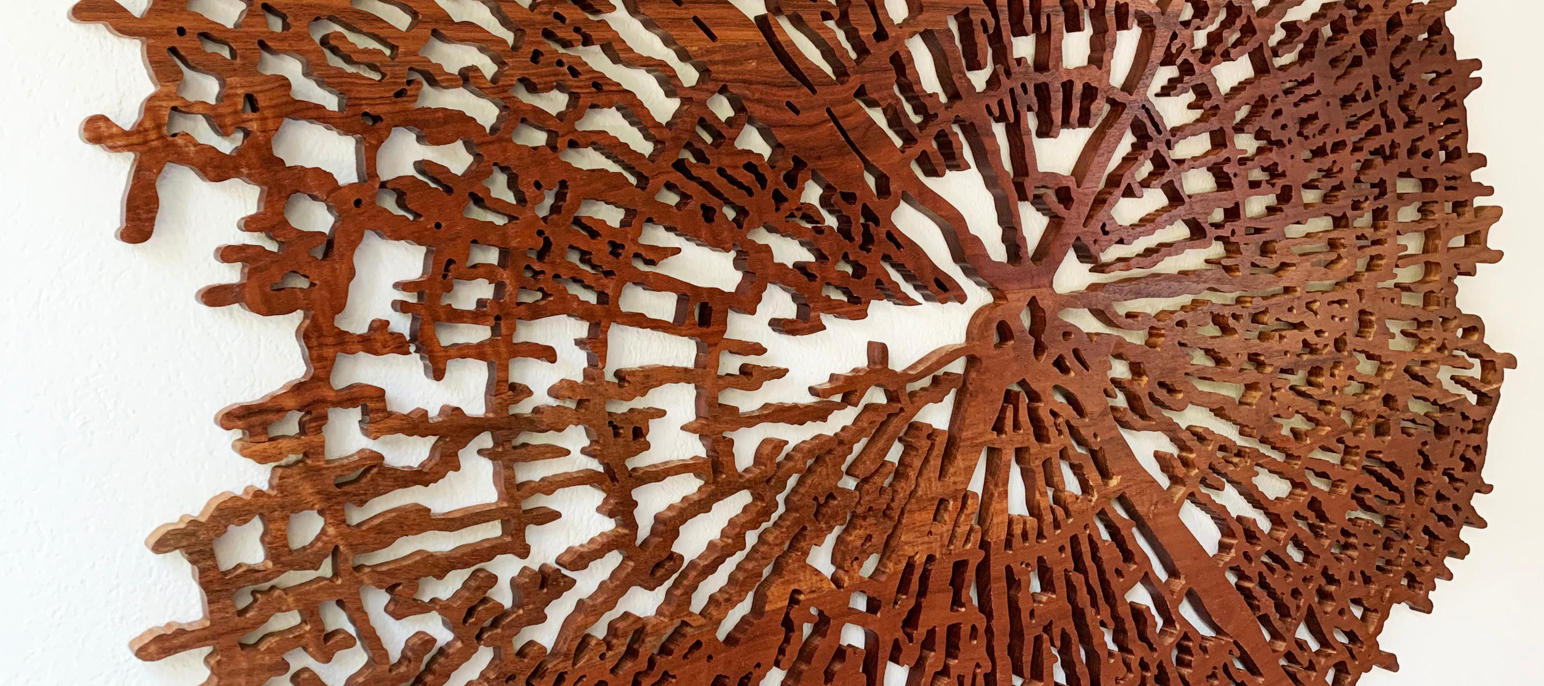 Dendrocronology is made with tropical solid wooden pieces with a varnish finish. Its details and contrast with the background wall make it an incredibly special piece. The artists were inspired by the growth of trees, and their interior natural