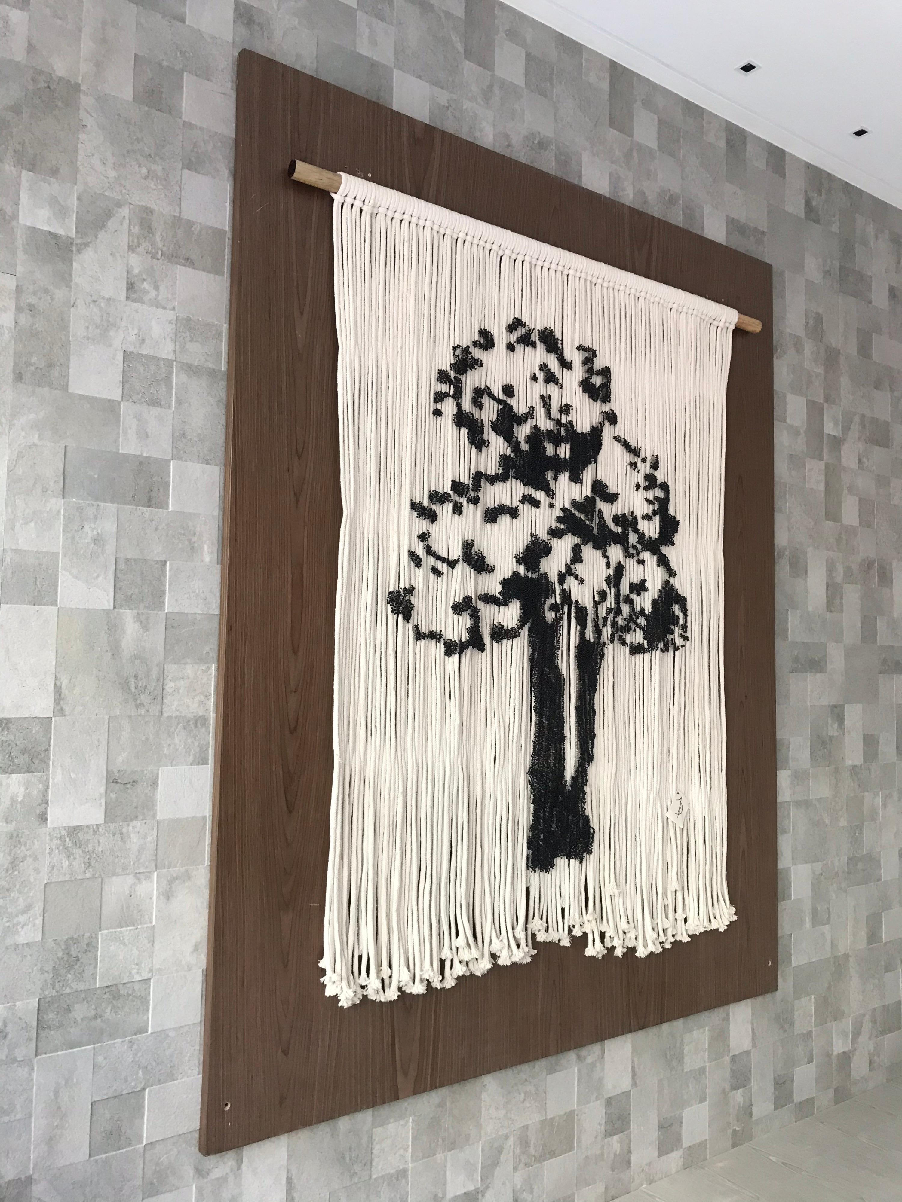 This elegant piece is handmade by two Mexican Artistis who managed to Project a tree silhouette upon cotton ropes. It is done with 17,570 delicately placed pins upon hanging ropes. The concentration of pins is what makes the shape of the tree