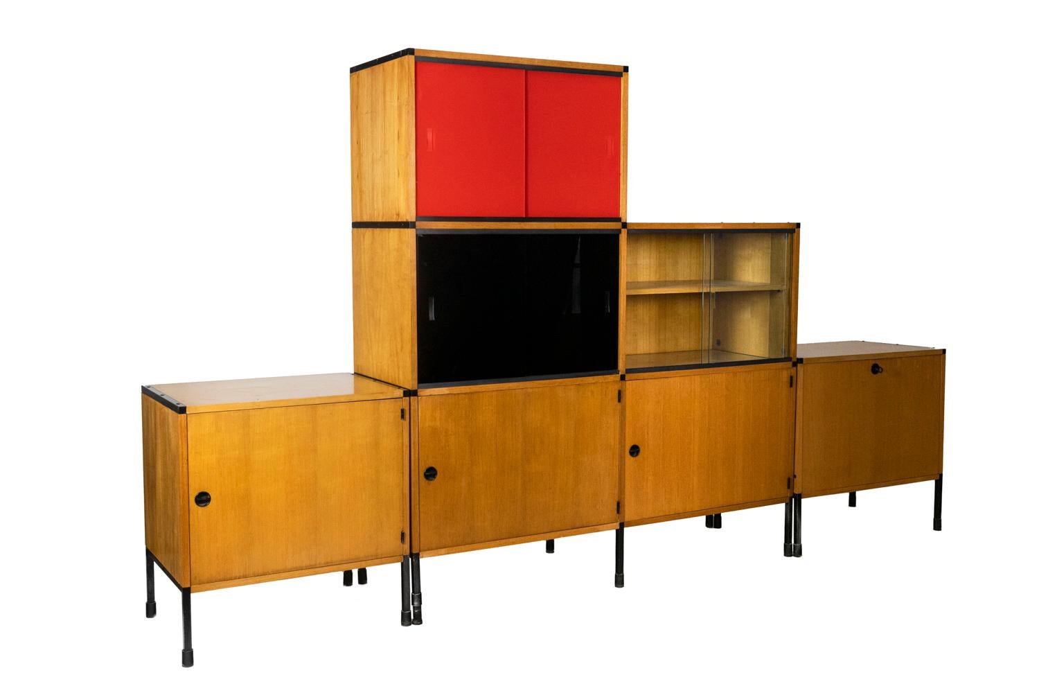 Arp, attributed to.
Minvielle, signed. 

Modular bookcase in blond oak. Four modules. Colored windows. Base in black metal. 

Work realized in the 1960s.

 