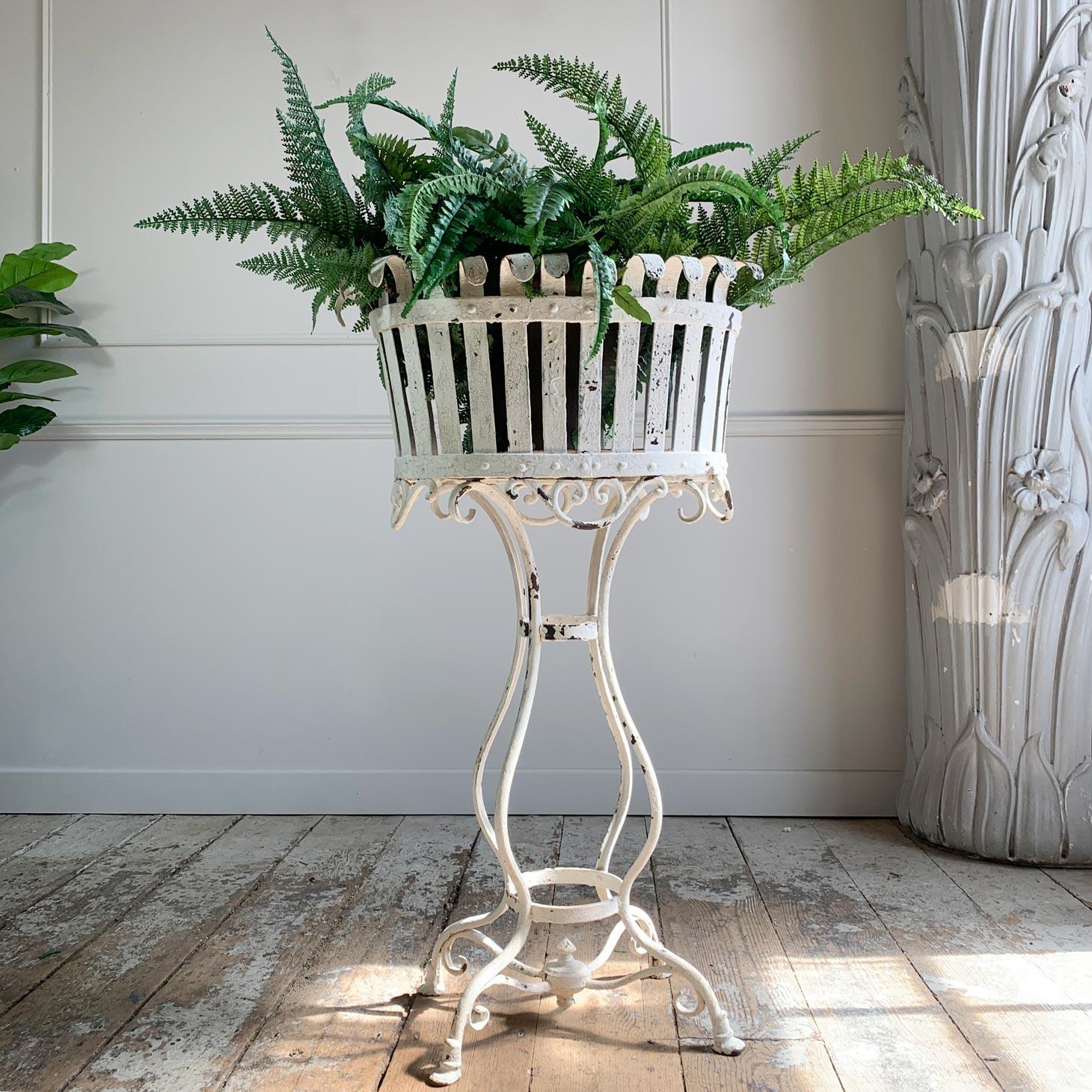Beautiful and rare Arras planter/jardiniere, this model with the horse hoof feet, dating it to the late 19th/early 20thcentury. The white painted wrought iron and riveted form has crackled in the most perfect way over the years, and the jardiniere