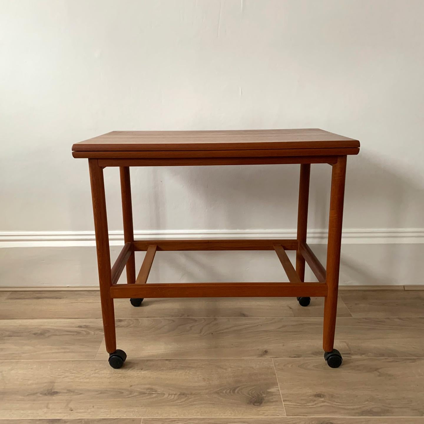 Arrebo mobler danish modern table. Danish teak serving trolley with folding top by arrebo mobler, 1960s features a convertible folding tabletop which measures: Table top folded out: 88 cm X 70 cm. Measures: Height: 64 cm, width: 70 cm, depth: 44 cm.