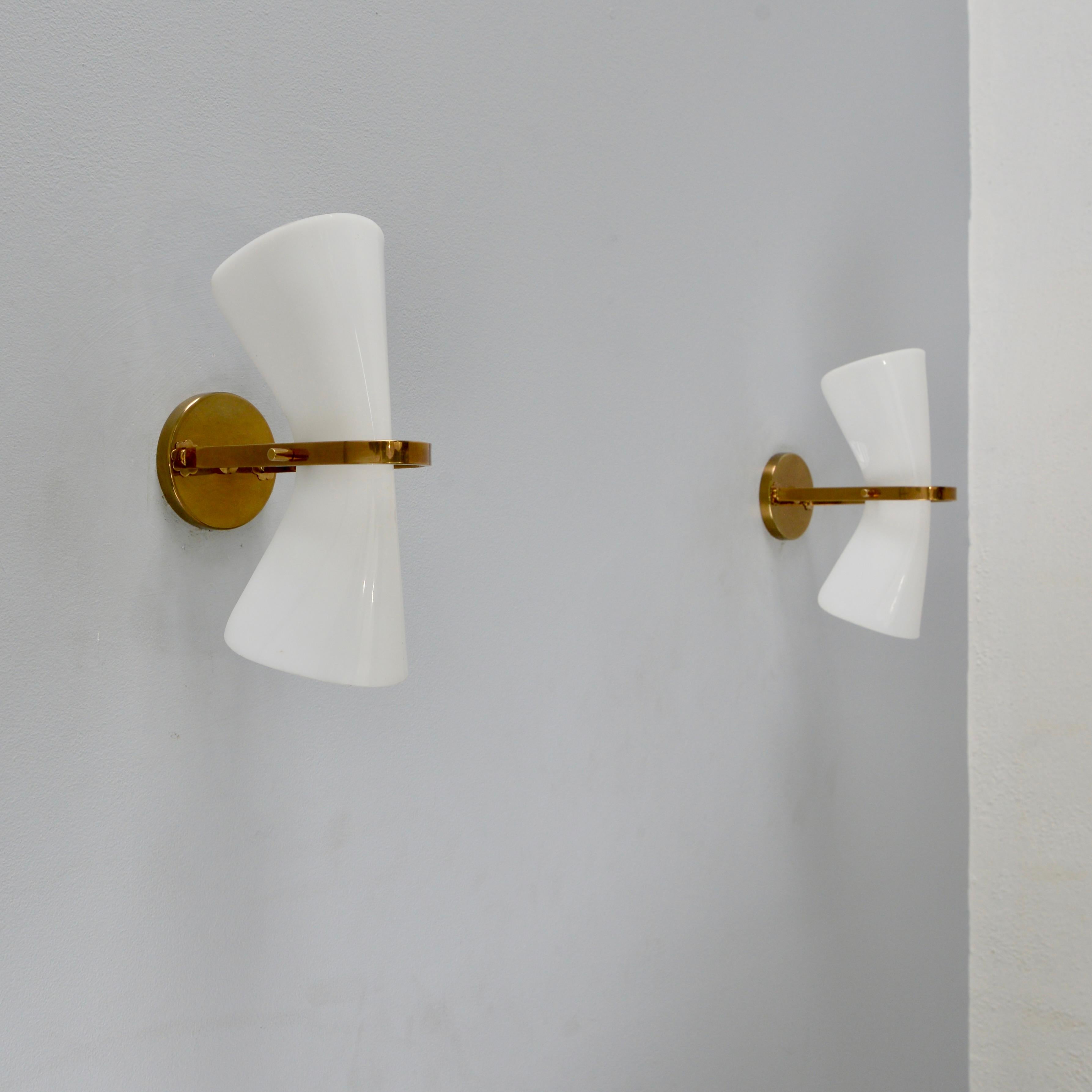 Elegant pair of Italian sconces from the 1950s attributed to Arredoluce. These sconces are in an aged solid brass finish and Metalcrilato, a high quality acrylic. Partially restored with (2) E12 candelabra based sockets per sconce, for use in the