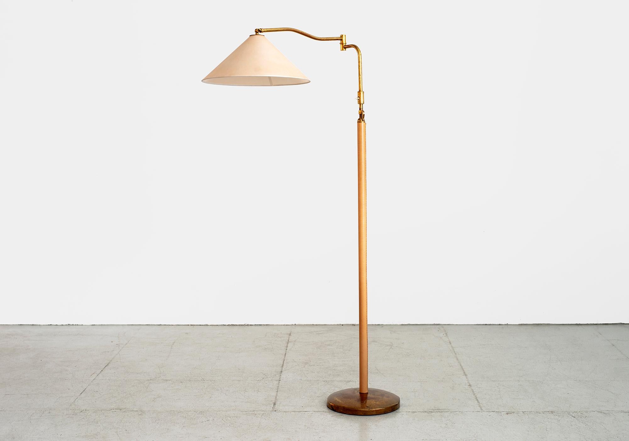 Beautiful floor lamp attributed to Arredoluce. 
Articulating and adjustable with great brass patina throughout and light tan leather stem. 
Top arm pivots and extends with wonderful brass joint. 
New silk shade and newly rewired.
