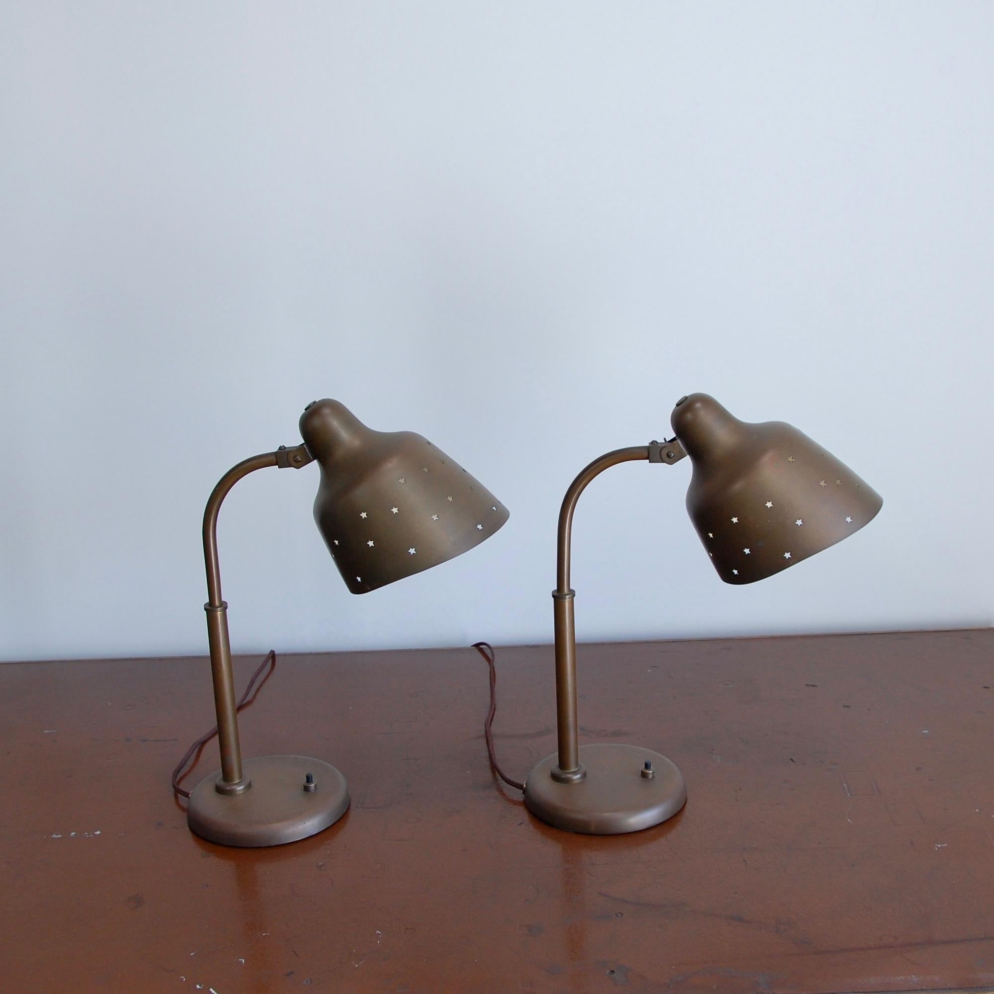 Pair of timeless brass Italian table lamps attributed to Arredoluce from the 1950s. Detailed with star perforations in the shades. Rewired with single E26 medium based socket per table lamp. Currently wired for use in the US. Priced as a