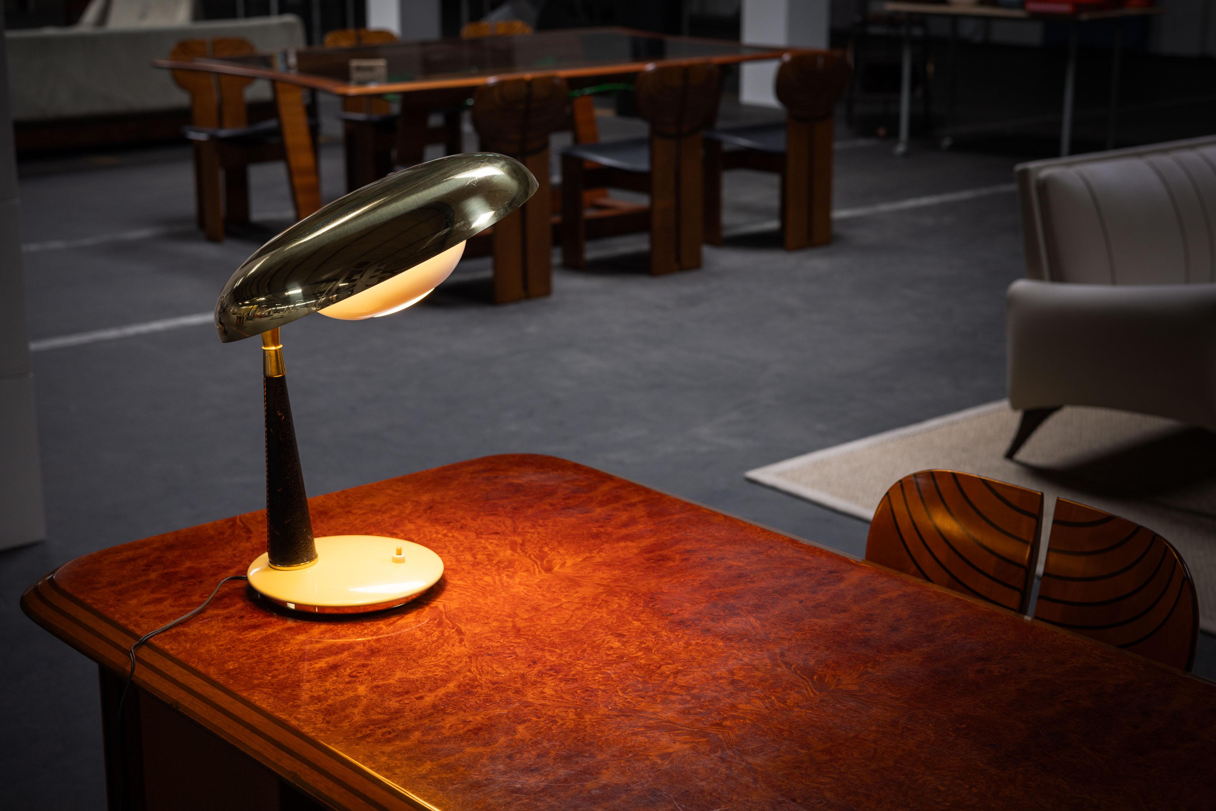 This remarkable table lamp, designed by Angelo Lelii and crafted by Arredoluce in Italy during the 1950s, exemplifies the elegance and innovation characteristic of mid-century Italian design. Arredoluce, known for their exceptional lighting