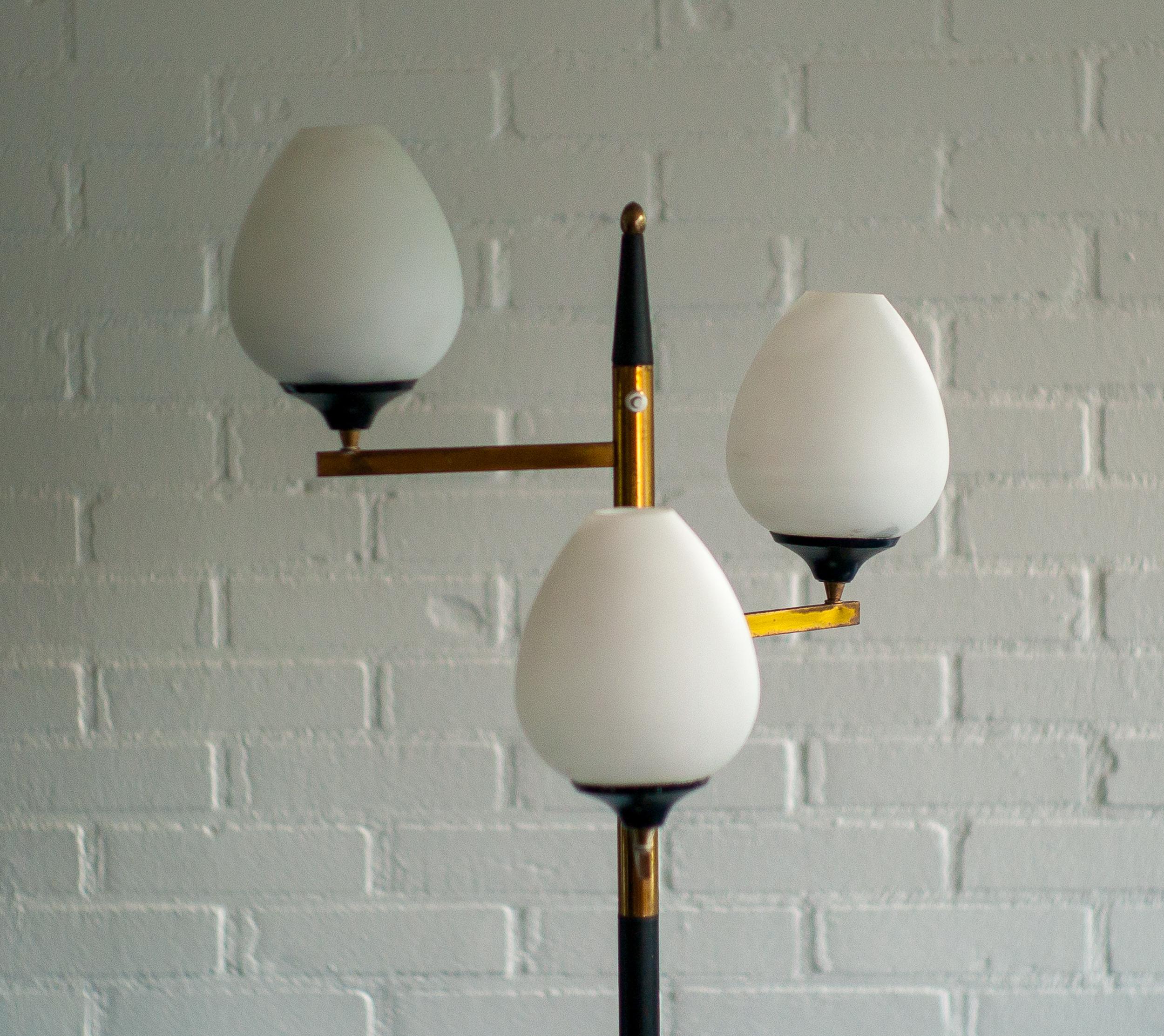 Elegant Italian floor lamp in brass with 3 swiveling opaline glass shades and a Carrara marble base. 
Marked with label, made in Italy Arredoluce Monza.
Can be rewired upon request.

Arredoluce, Monza is an iconic Italian lighting company renowned
