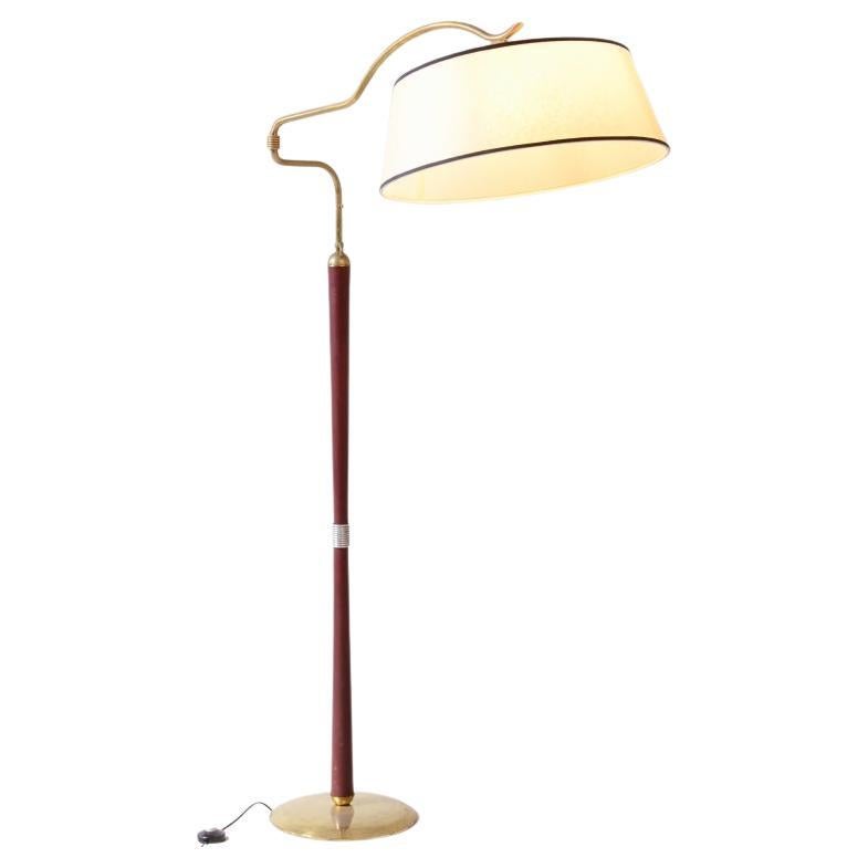 Arredoluce floor lamp with a dark red leather and brass-covered stem