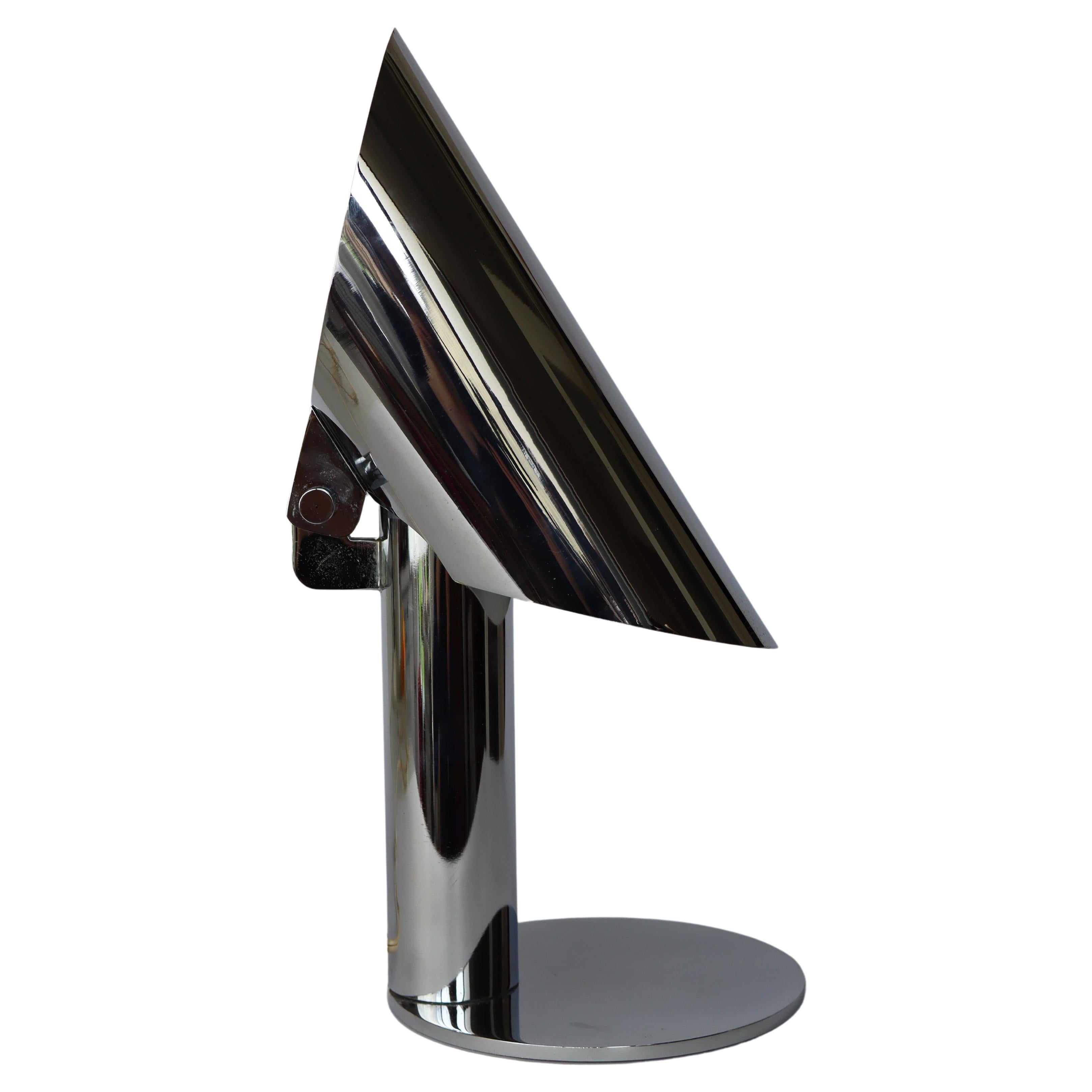 Arredoluce table- or desklamp in chrome.

A 1972 design by this great italian manufacterer of lighting ( existing since 1939)

Can be used as a simple desklamp or as an uplighter, seen you can move the shade, which is the chrome tube.
This great an