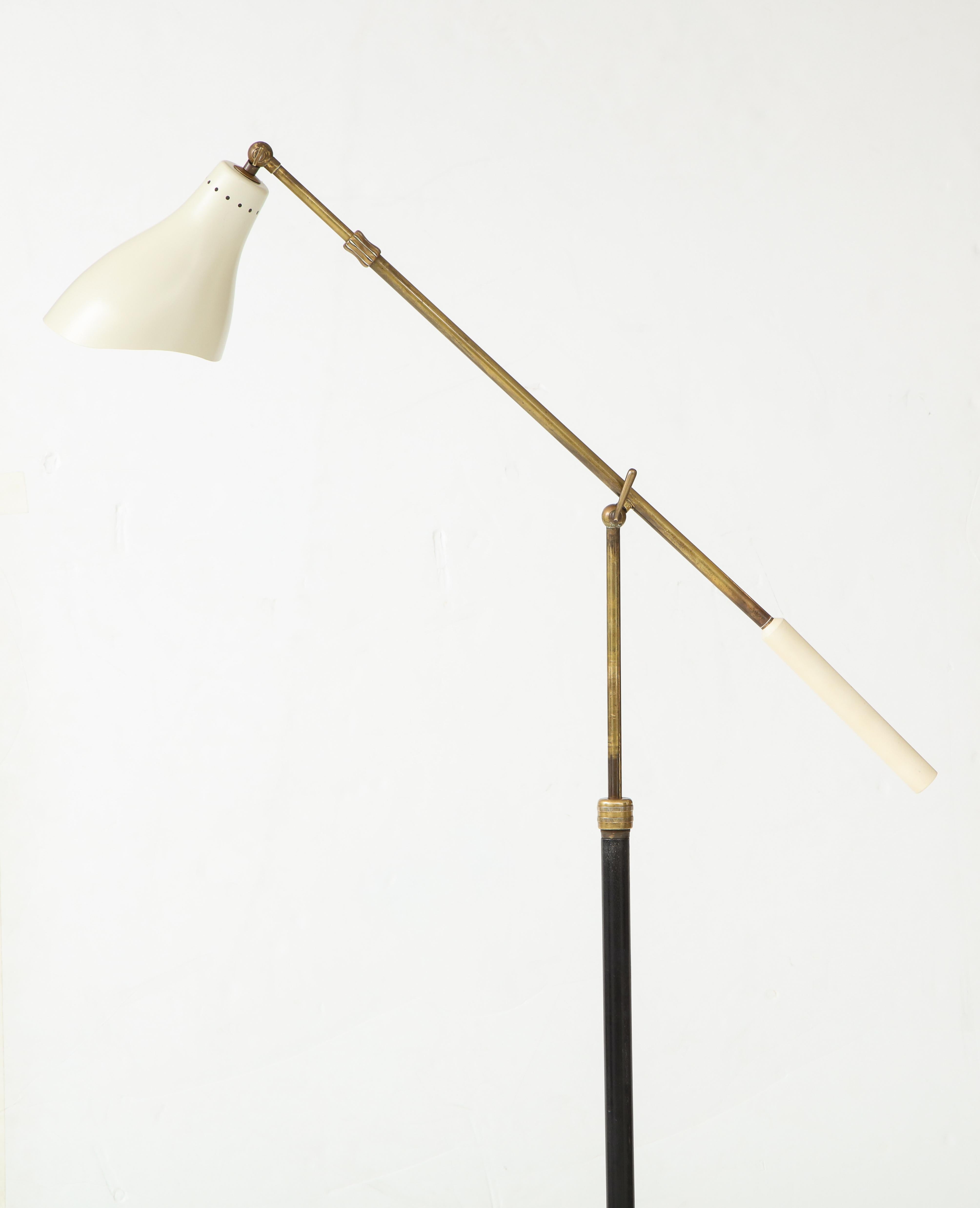Early and rare Angelo Lelii for Arredoluce articulating floor lamp with pivoting off-white lacquer perforated aluminum shade on brass arm adjustable to various heights by way of an internal system at the central joint and controlled by the