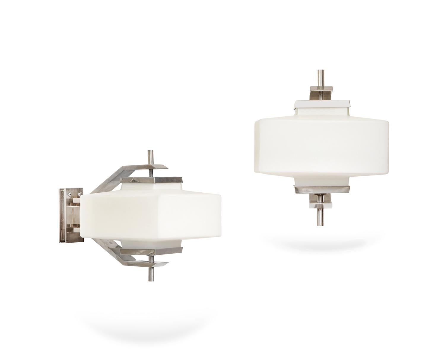 Rare pair of sconces by Elio Monesi for Arredoluce
Model # 12822 Texas. Nickeled metal structures with satin glass diffusers. Each sconce has 1 standard Edison socket. Newly-made wall plates to cover USA junction boxes. Very good original