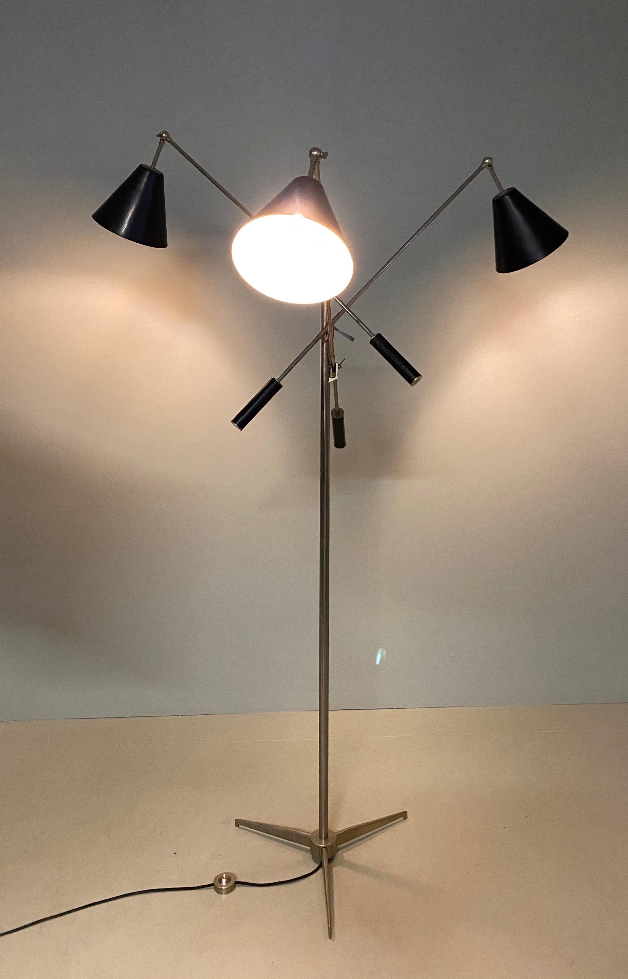 Angelo Lelli for Arredoluce, Triennale floor lamp, brass nickeled. l, Italy, circa 1953. This iconic lamp was designed by Angello Lelii for Arredoluce in Italy in 1953. It has three shades, black, each mounted on a long rod and clustered on a metal