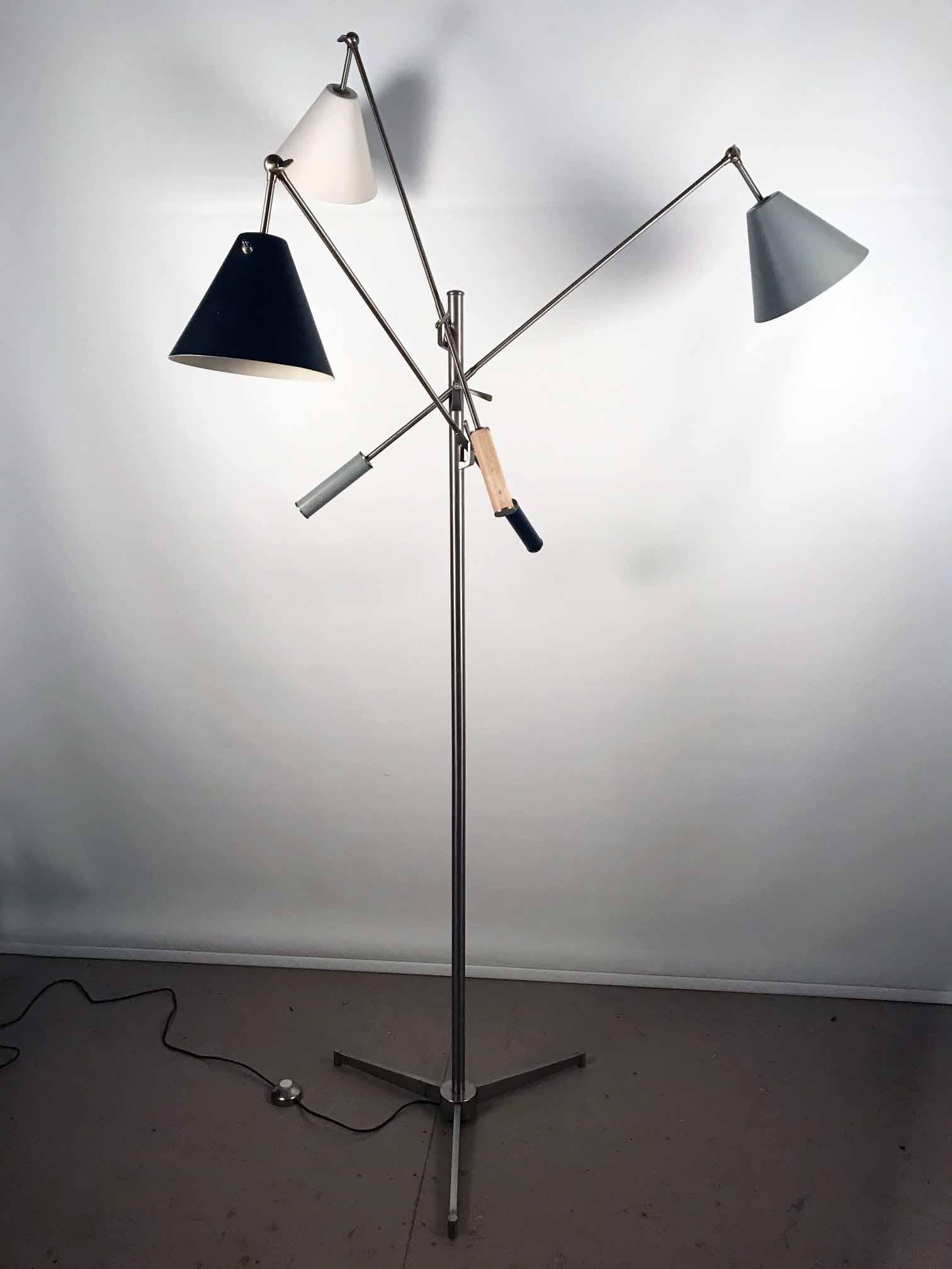 Angelo Lelli for Arredoluce; Triennale floor lamp, brass and enameled metal, Italy, circa 1953 

This iconic lamp was designed by Angello Lelli for Arredoluce in Italy in 1953. It has three shades, black, white and green, each mounted on a long