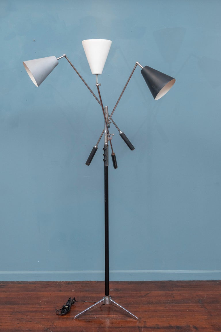 Arredoluce Triennale style three arm floor lamp, stamped made in Italy. 
Newly restored with new sockets, switches and wiring which all work perfectly. Chrome plated tripod base and arms all in good condition with black leather wrapped handles and