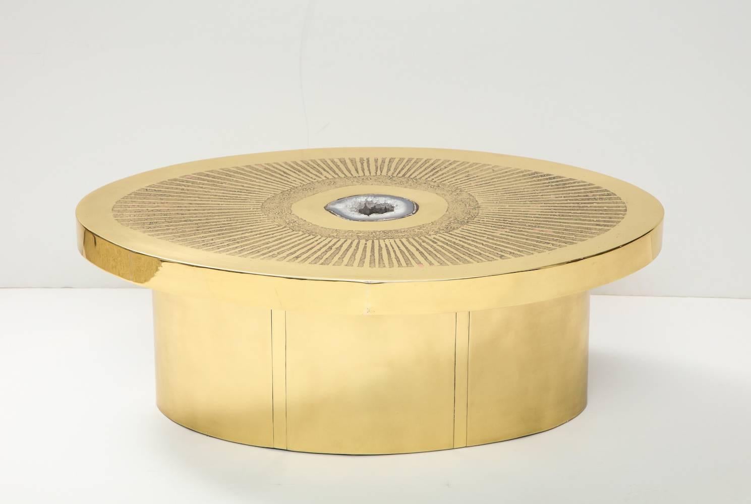 Unique cocktail table with inset Geode, by Arriau.
Studio-built ovoid form of polished brass with acid-etched surface pattern. Centre is inset with Geode of Agate creating a beautiful effect. This table in completely crafted by hand in France.