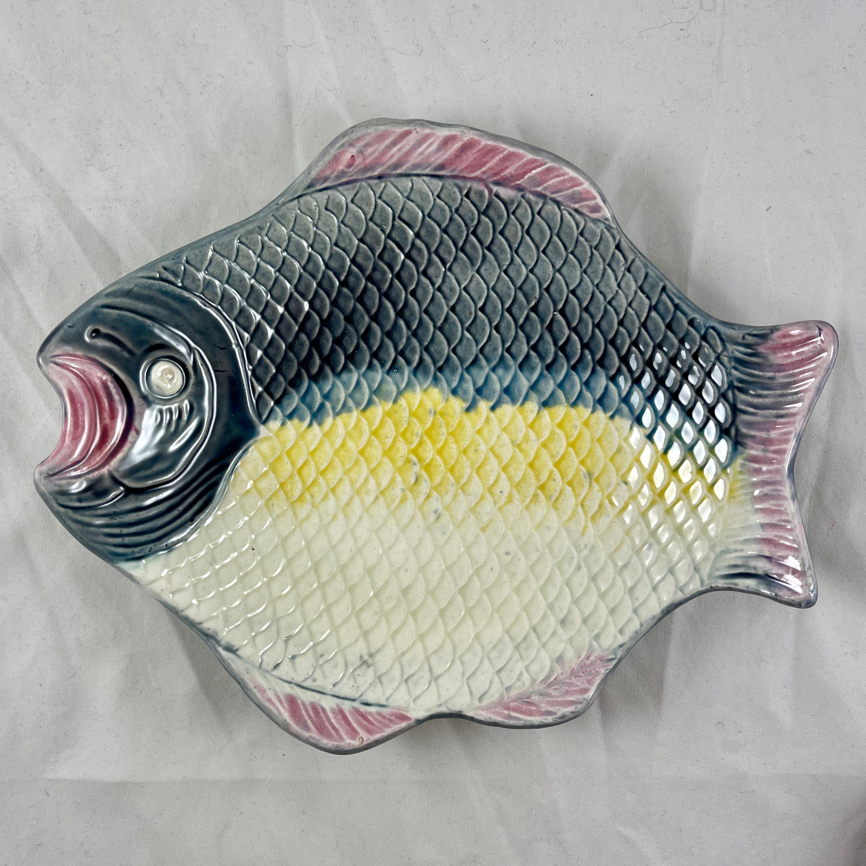 A rustic majolica fish platter made by the Arsenal Pottery of Trenton, New Jersey, circa early 1880s.

The platter is realistically molded as a shallow bowl, and has wonderful soft coloring, glazed in tones of blue-gray, yellow, and cream with pink