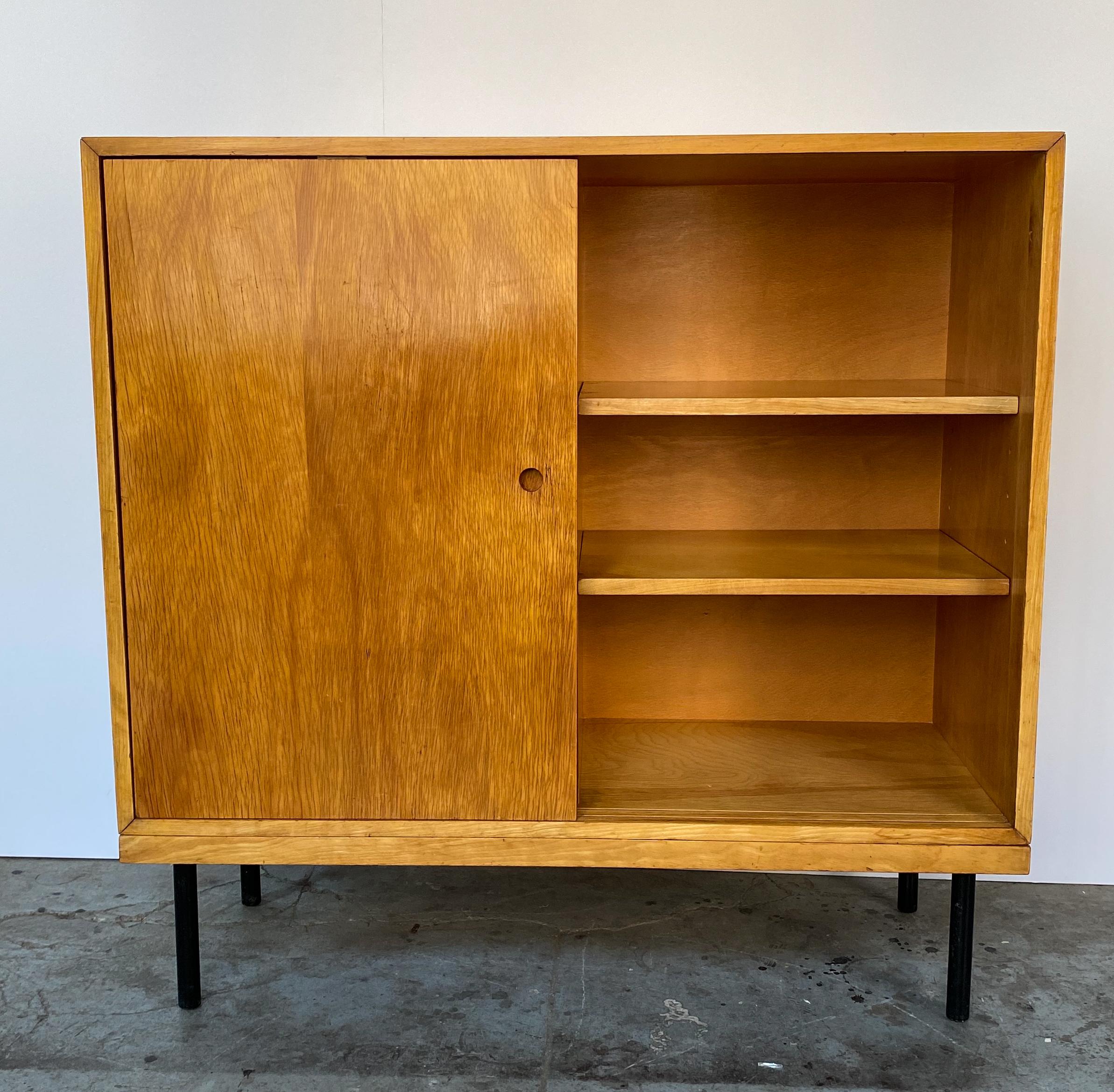 Custom and well-crafted modular sliding-door cabinet produced by Eric R.E. Schuster of the Art and Trade Shop of New York City in the early 1940s. Stylistically related to case goods designed for the MoMA Organic Design in Home Furnishings