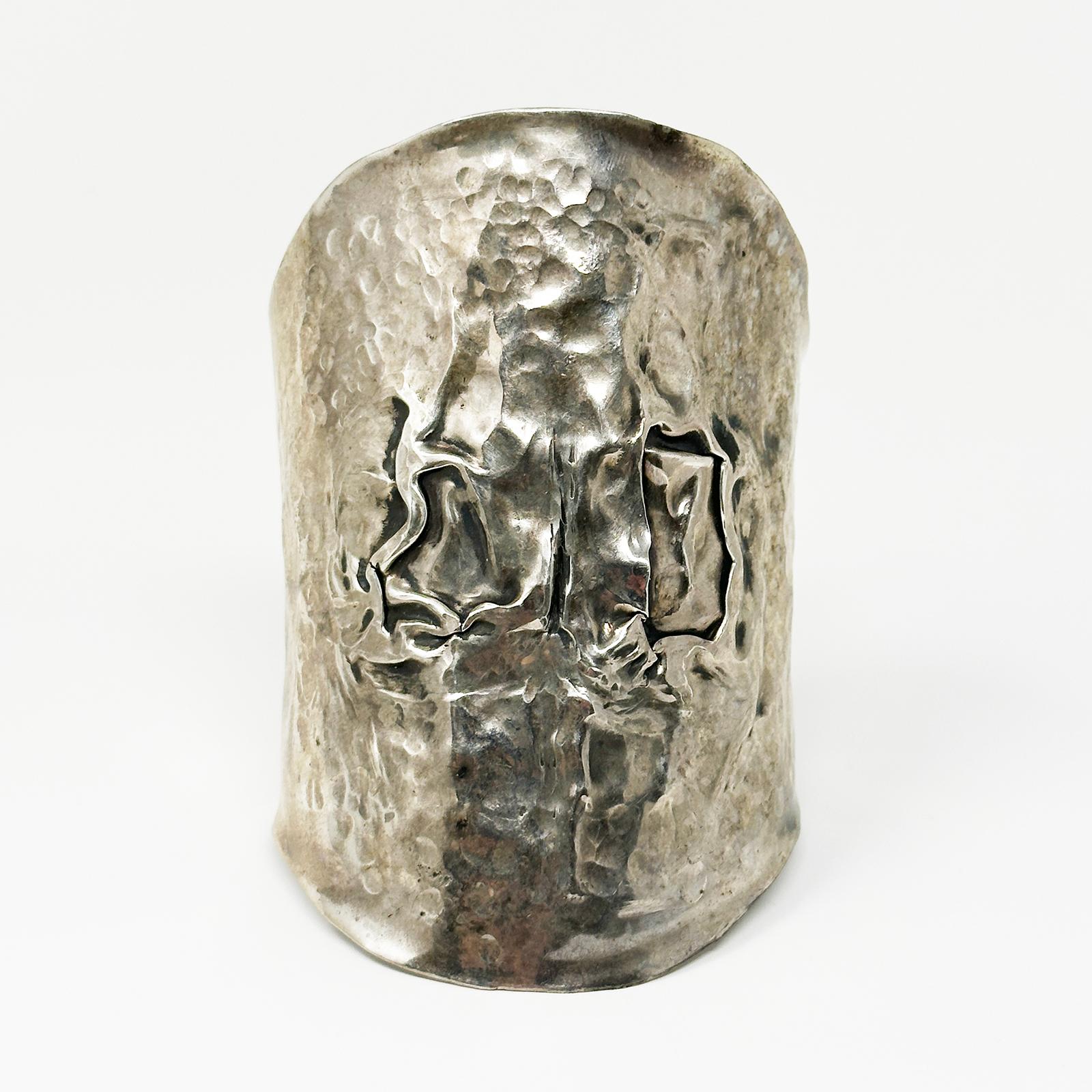 Polsino Art Brut Moderno in argento fatto a mano

Si tratta di un bracciale regolabile in argento martellato a mano, probabilmente realizzato artigianalmente negli anni Ottanta. Misura 3-7/8 pollici di altezza con un diametro interno di 2,5 pollici.