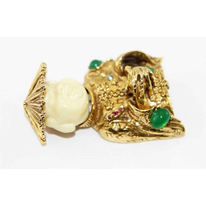 Gorgeous Vintage Buddha design brooch, Made of ivory resin, crystal stones and emerald glass cabochons, gold plated metal. Rare to find. 

Signed: Art copyright
Size: 5.5  x 3  cm
Excellent Vintage condition