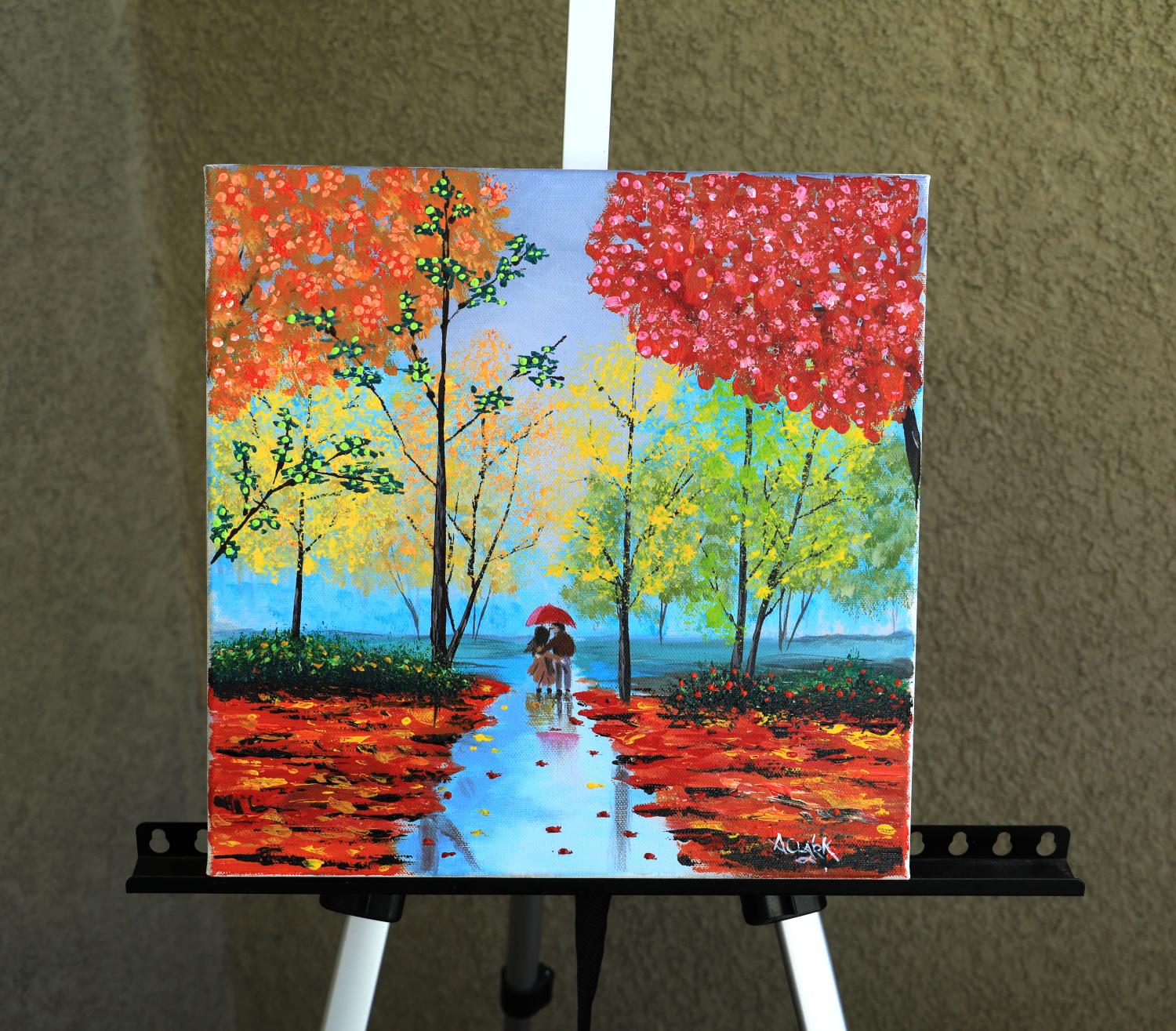 <p>Artist Comments<br>A couple walks hand-in-hand through a vibrant autumn forest. Their cheerful, colorful attire contrasts with the gentle rain. The wet leaves on the trees shimmer with brilliant reds, oranges, and yellows, reflecting the soft