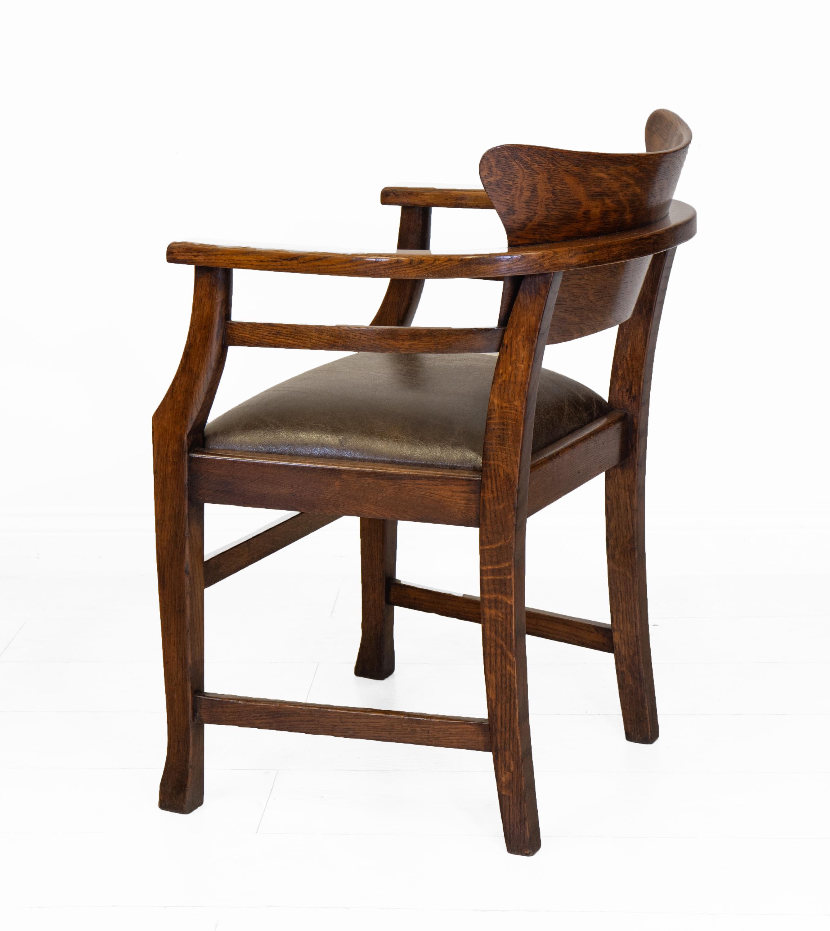 Arts & Crafts oak and leather desk chair, Jugendstil, in the Richard Riemerschmid manner. Retailer's label: Solomon Bros, London. Circa 1900. 

The chair is stamped E.S. to the underside, presumably the cabinetmaker. 

The chair has a continuous arm