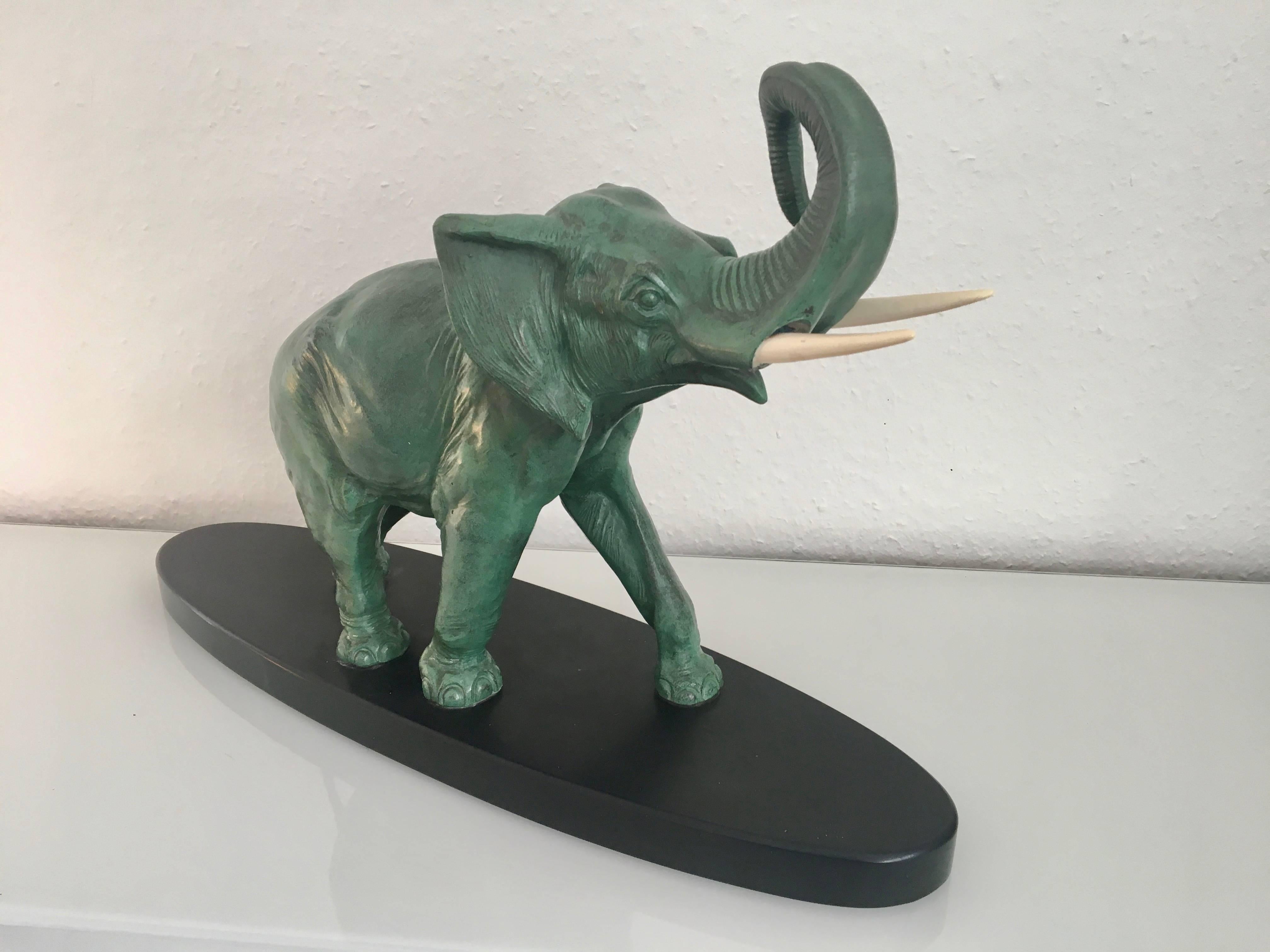 A majestic illustration of an elephant raising high his trunk.
The sculpture is made in the style of 
