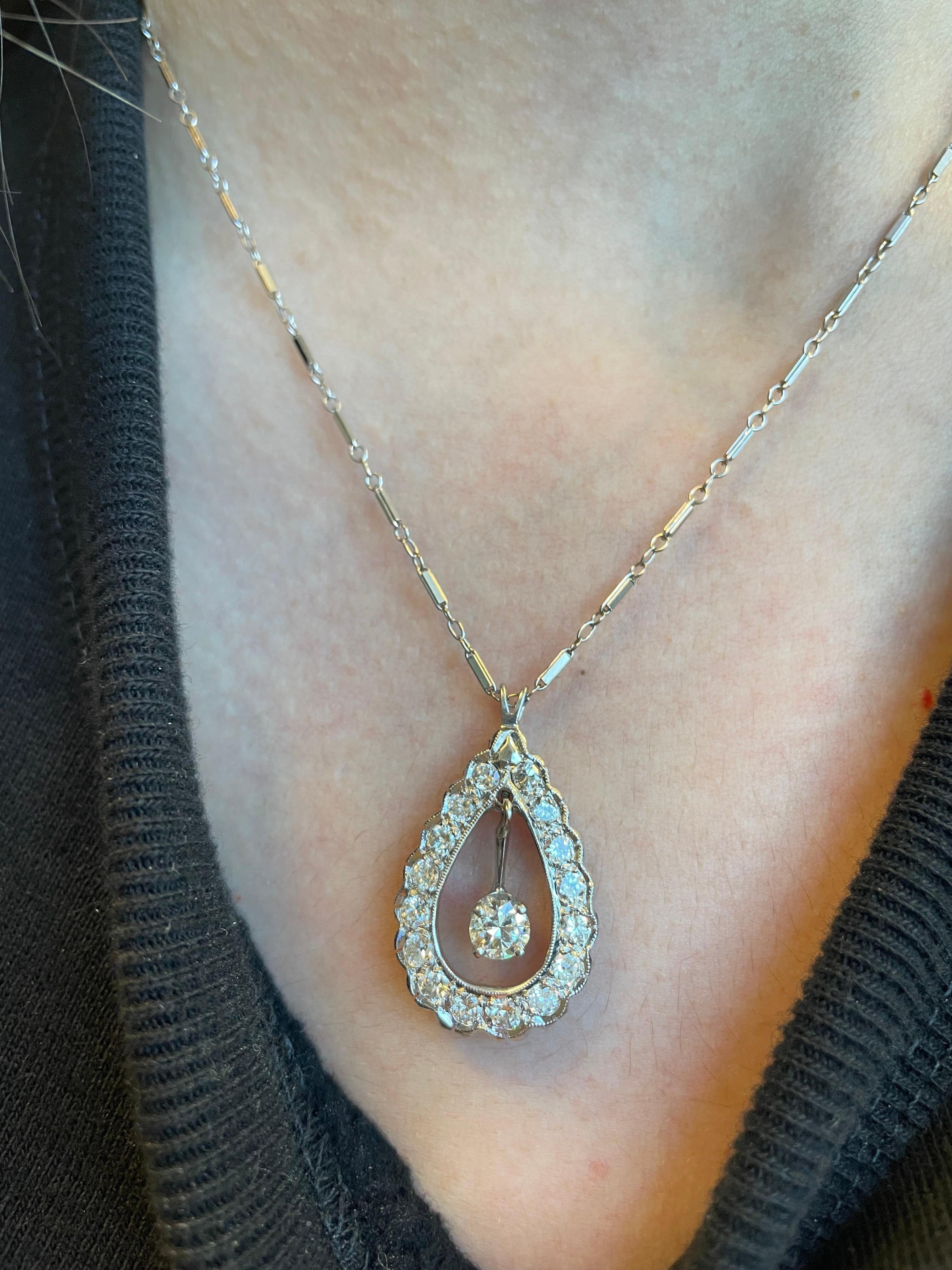 Art Deco inspired diamond pendant with dangling diamond.
Approximately 1.50 carats of round brilliant diamonds, G/H color and VS2/SI1 clarity. Center stone approximately 0.50 carats. 14k white gold.
Accommodated with an up to date appraisal by a GIA