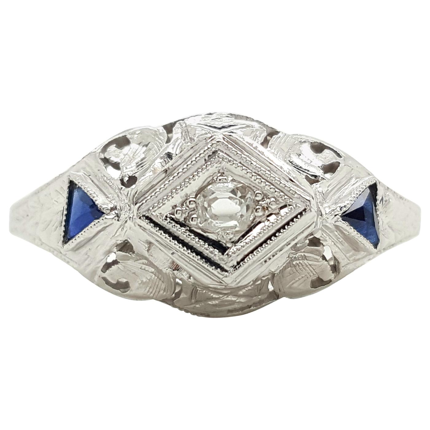 Art Deco 0.15 Carat Oval Cut Diamond and Blue Sapphire Engagement Ring