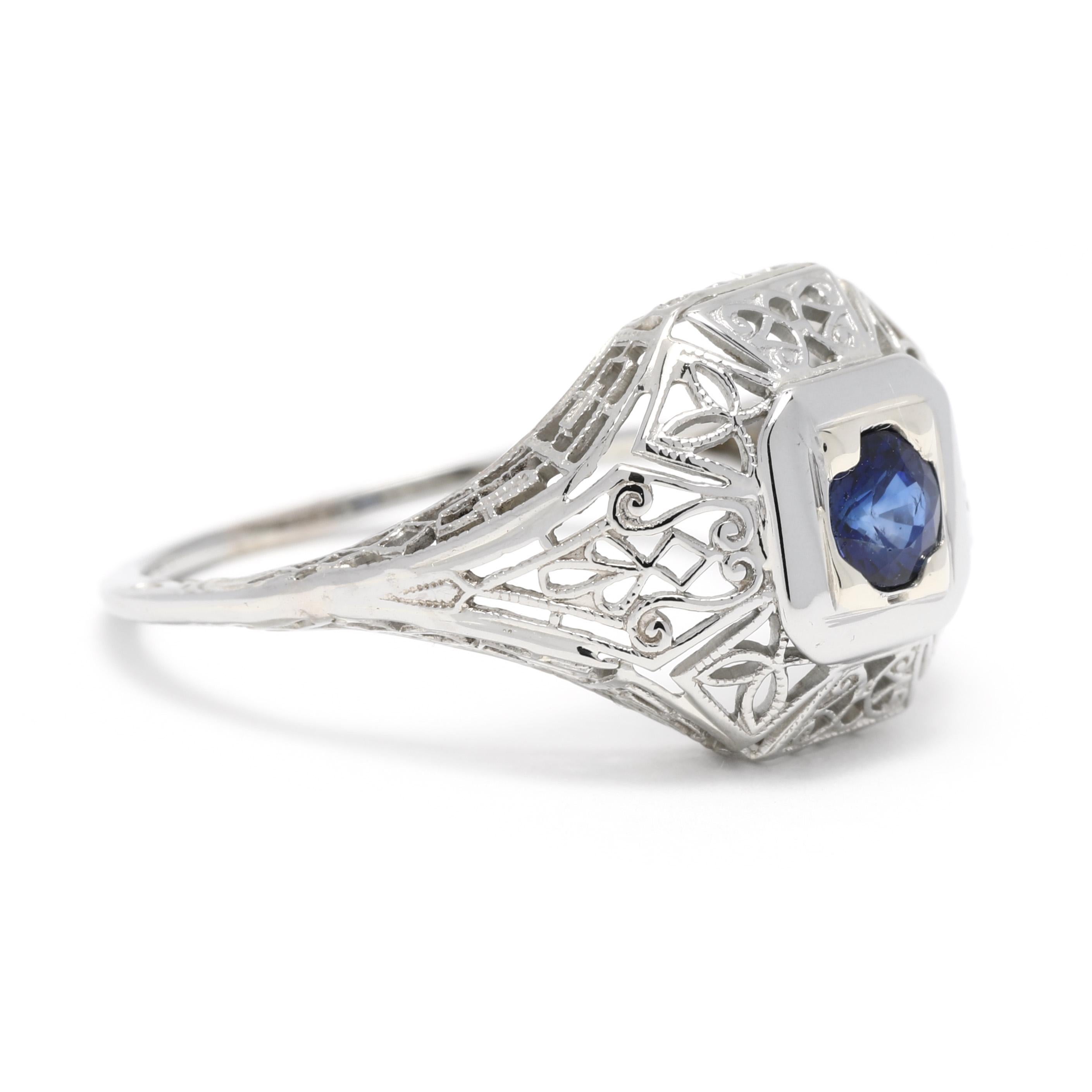 An Art Deco 14 karat white gold sapphire filigree cocktail ring. This September birthstone ring features a tapered design with a square set, round cut sapphire weighing approximately .35 carat, with a floral filigree design.

Stones: 
- sapphire, 1