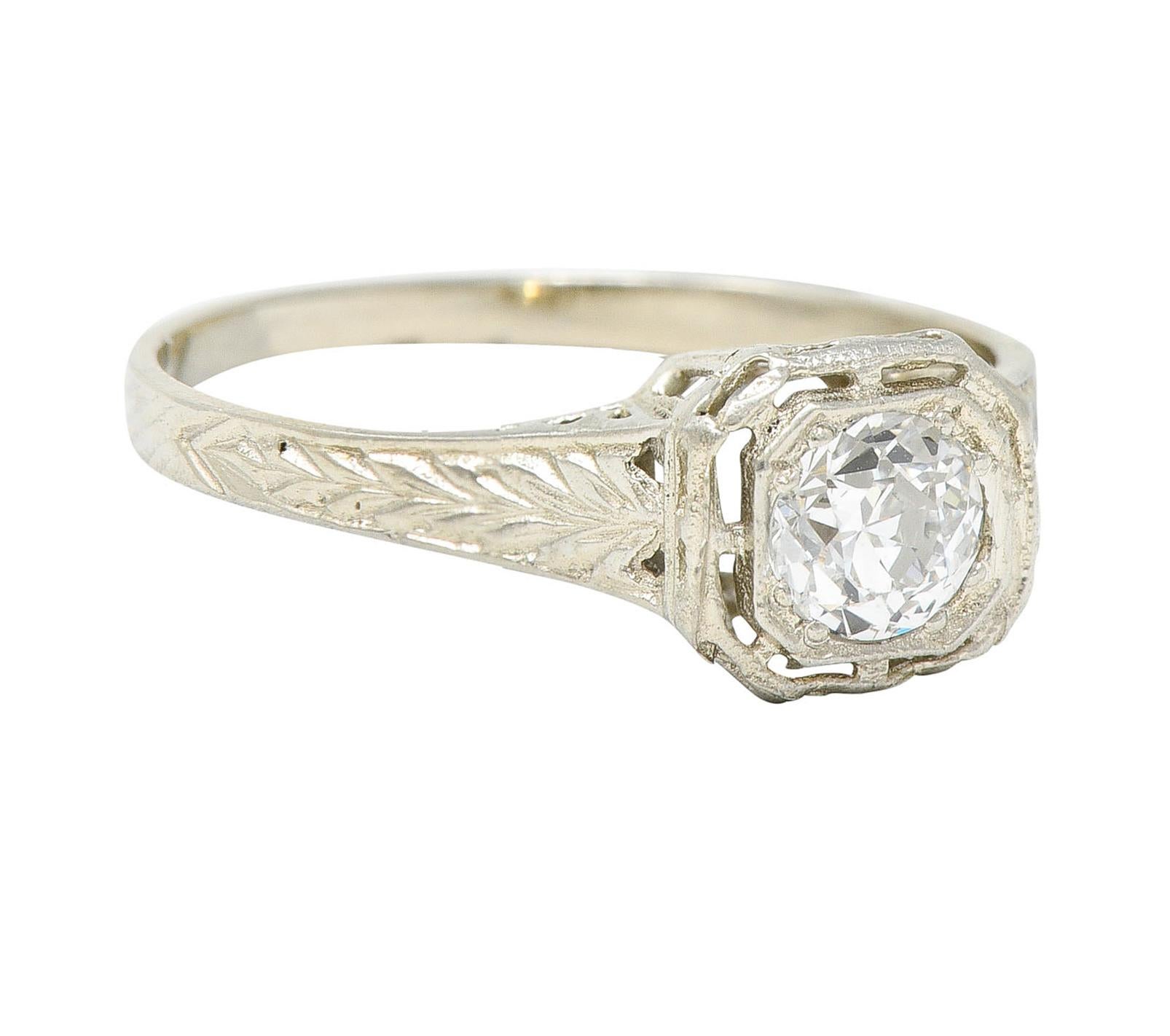 Featuring an old European cut diamond weighing approximately 0.39 carat - G/H color with VS2 clarity

Set low in a cushion head pierced with stylized ears of wheat

Shoulders are engraved with a matching wheat motif pattern

Stamped 14K for 14 karat