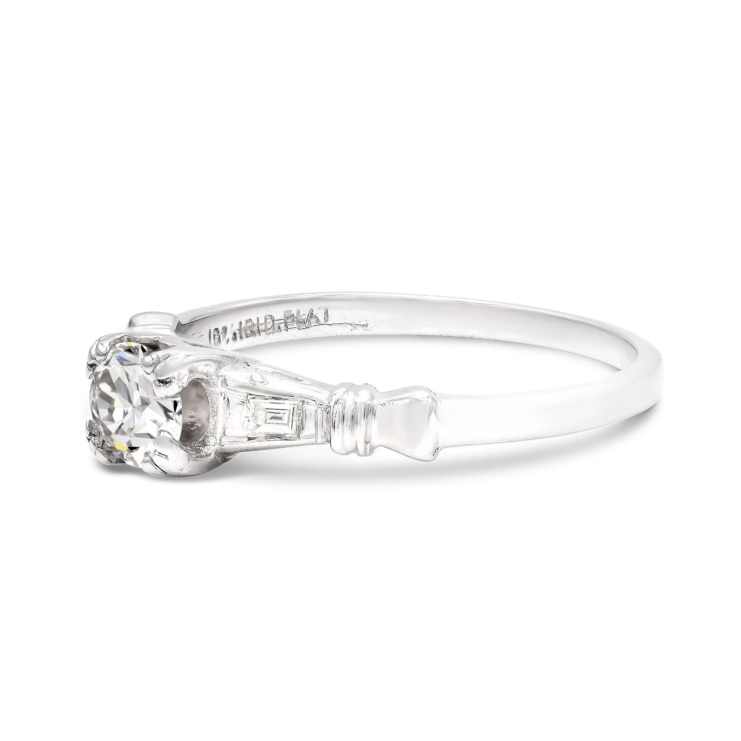 A sweet old European cut diamond is the star of this art deco engagement ring style. Graded F VS2 by GIA, it's icy-white and the perfect complement to this super charming platinum setting. We love the geometric shoulders, accented with two tiny