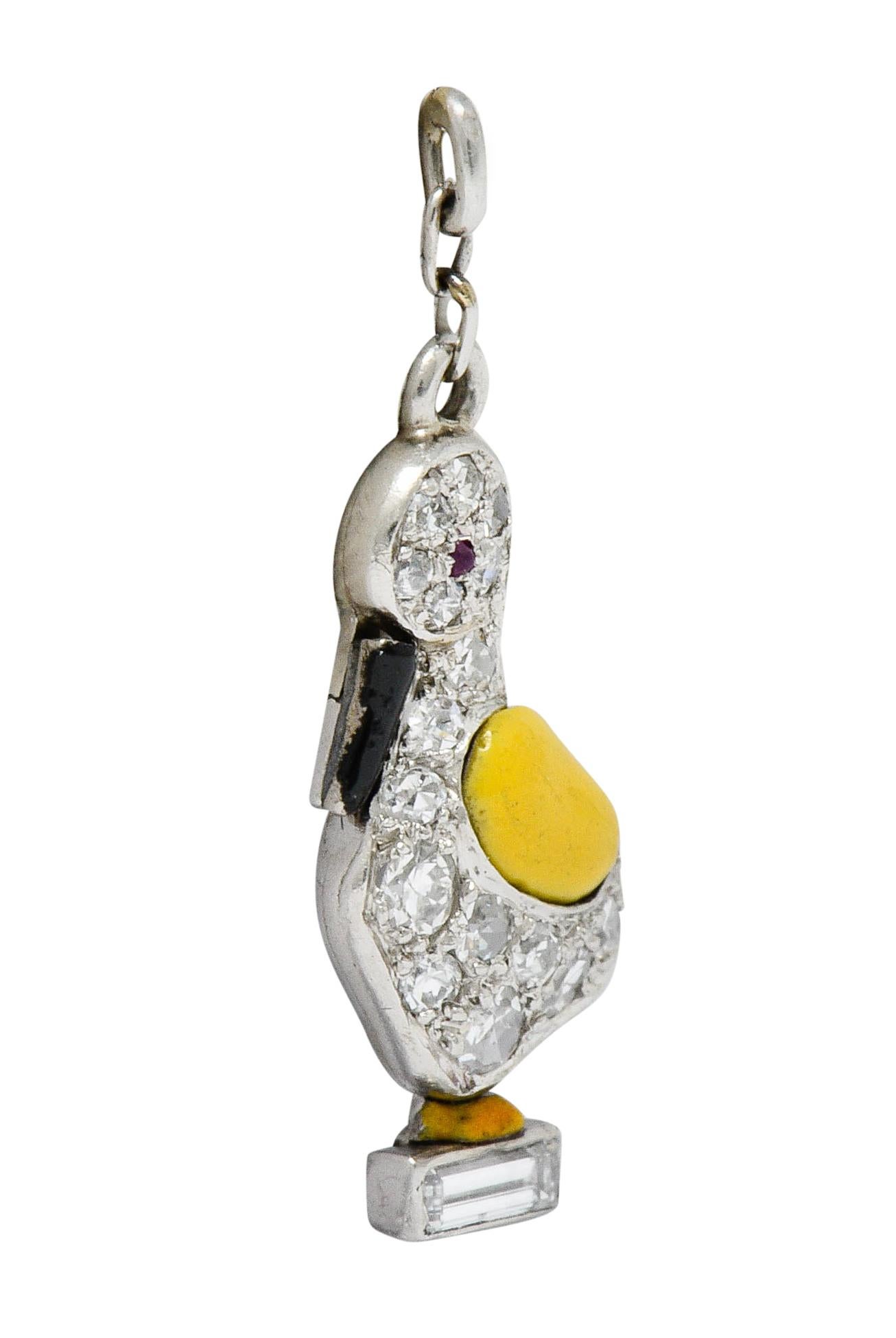 Designed as a stylized goose with a small ruby cabochon as its eye

Set throughout by single and baguette cut diamonds weighing in total approximately 0.45 carat; eye-clean and white

Glossed with black and yellow enamel that exhibits minor loss;