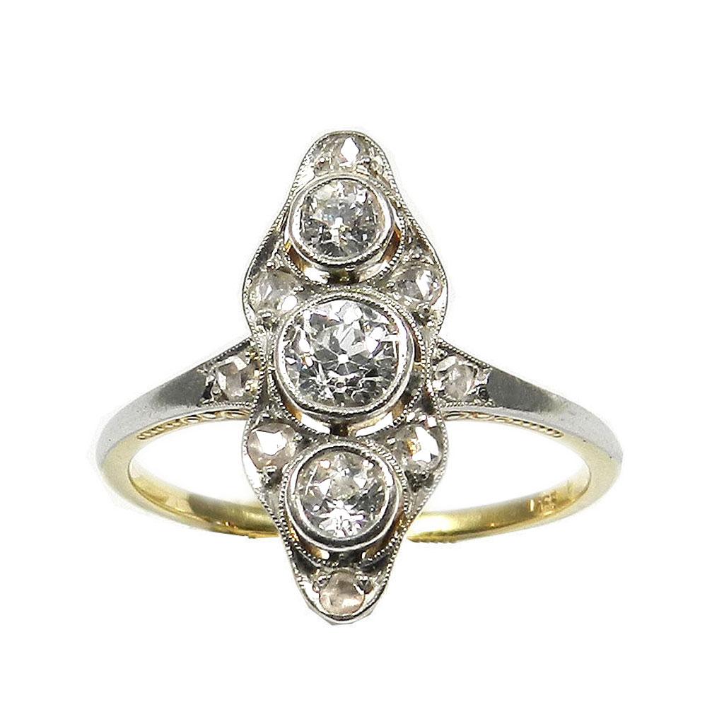 Art Deco 0.45 ct Diamond Gold and Platin Ring, circa 1930

Decorative boat shaped diamond ring with fine engravings on the side, the pierced ring head set with 3 old-cut diamonds totaling 0.37 ct, framed by 8 smaller rose-cut diamonds, 0.45 ct in