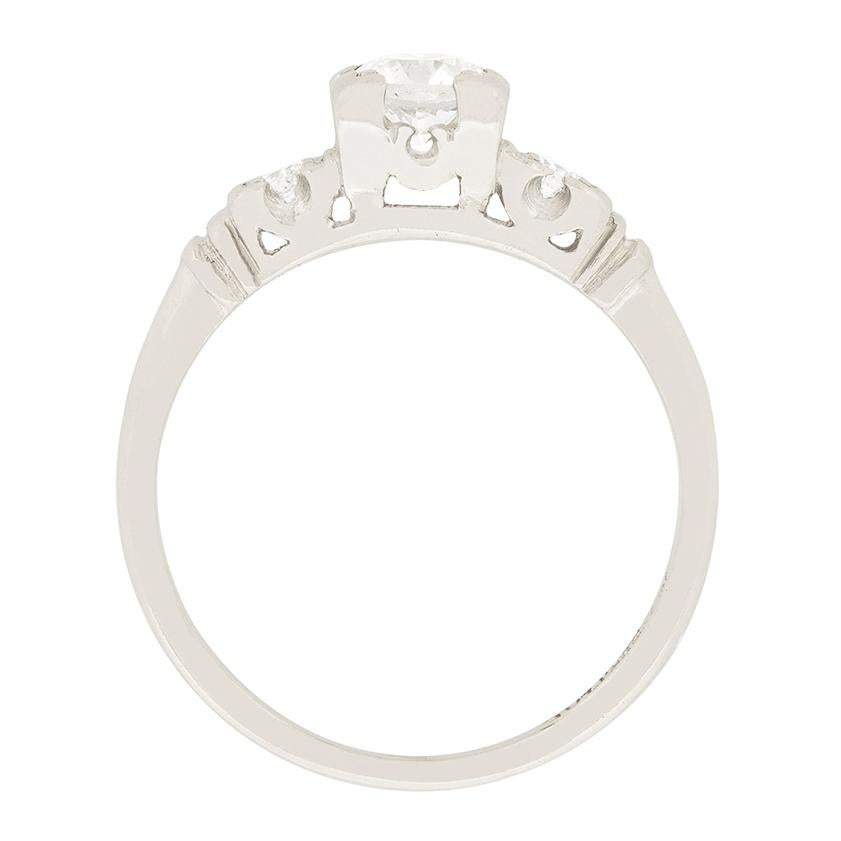 The classically art deco engagement ring highlights a 0.45 carat diamond within a platinum setting. The diamond is transtional cut and is an F colour grade and VS1 clarity grade. A 0.05 diamond is set on each shoulder. The diamonds are held within